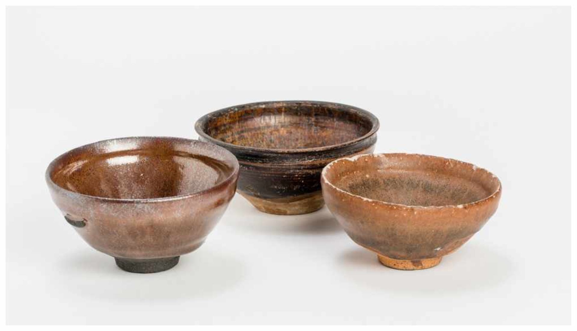 THREE CHINESE GLAZED CERAMIC DRINKING BOWLS Glazed ceramic. China, Song to Yuan dynastyThese