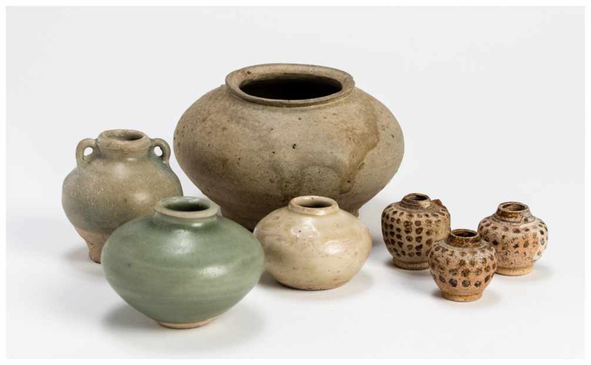 SEVEN SMALL AND LARGER CHINESE POT VESSELS Partly glazed ceramic. China, Song to Ming dynastyThe