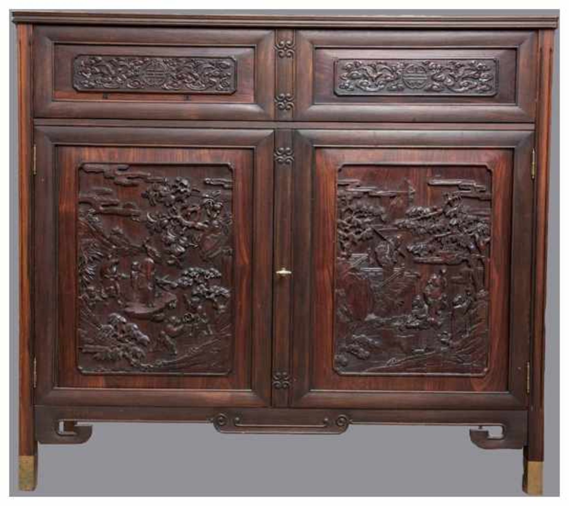 AN ELEGANT DARK HARDWOOD CABINET Hardwood, brass. China, 20th CenturyFinely carved in relief with