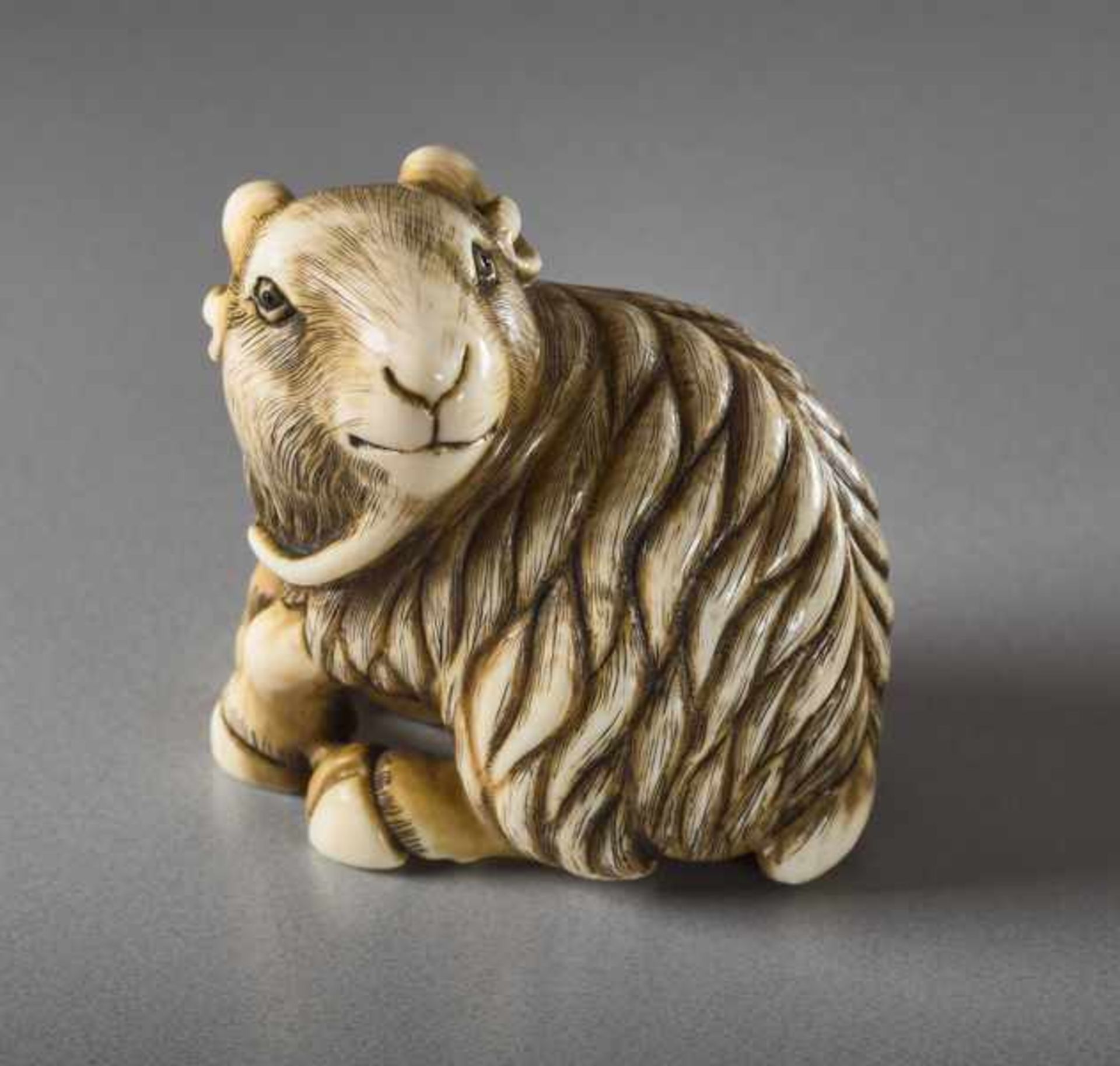 AN IVORY NETSUKE BY KANGYOKU OF A GOAT Ivory netsuke. Japan, 20th centuryKangyoku is one of the