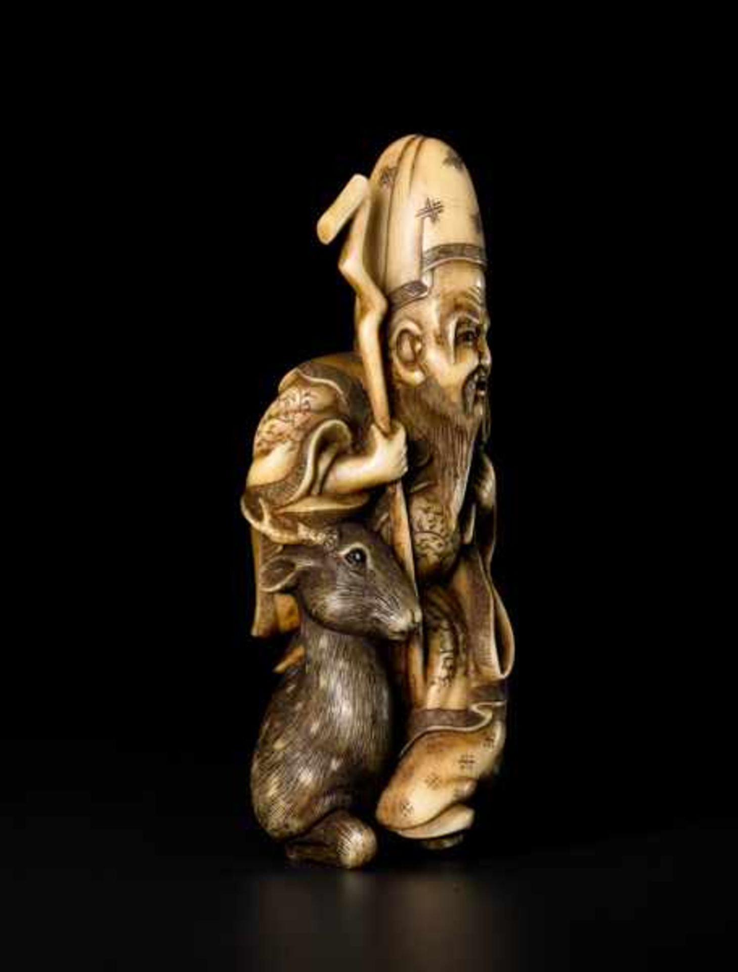 AN IVORY NETSUKE OF JUROJIN Ivory netsuke. Japan, 19th centuryJurojin, Japanese for “long-lived, old - Image 2 of 6