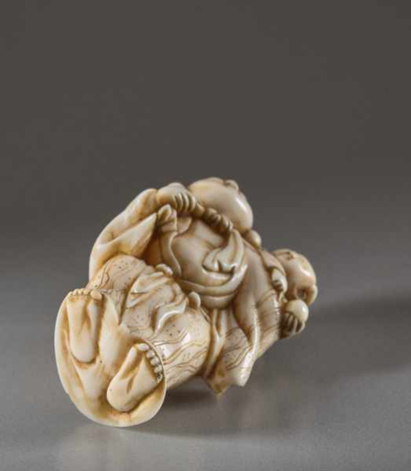 AN IVORY NETSUKE OF HOTEI WITH KARAKO Ivory netsuke. Japan, early 19th centuryA very lively - Image 5 of 5