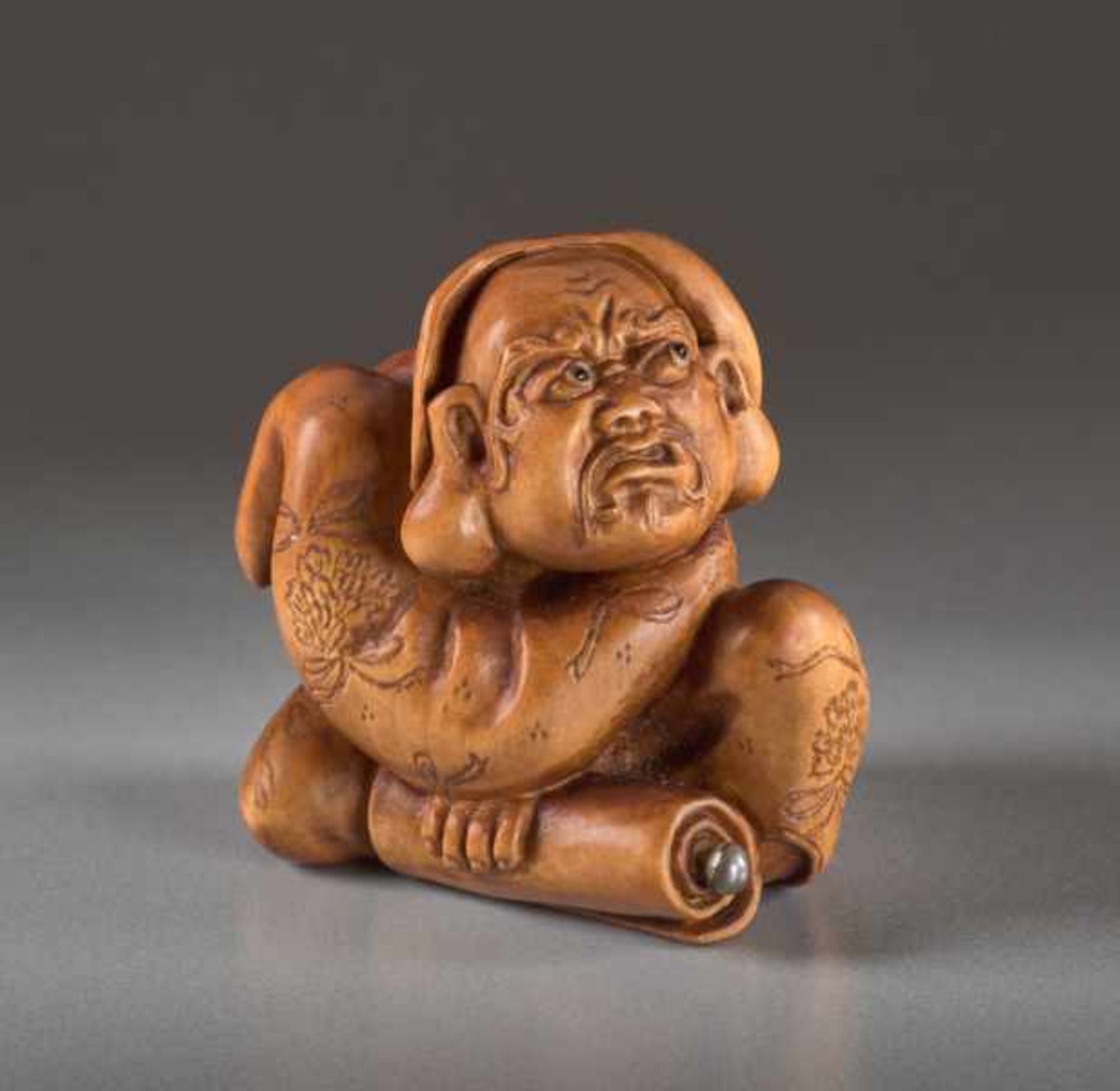 A BOXWOOD NETSUKE BY ALEXANDER DERKACHENKO OF DARUMA Boxwood netsuke. Japan, Daruma is the famous