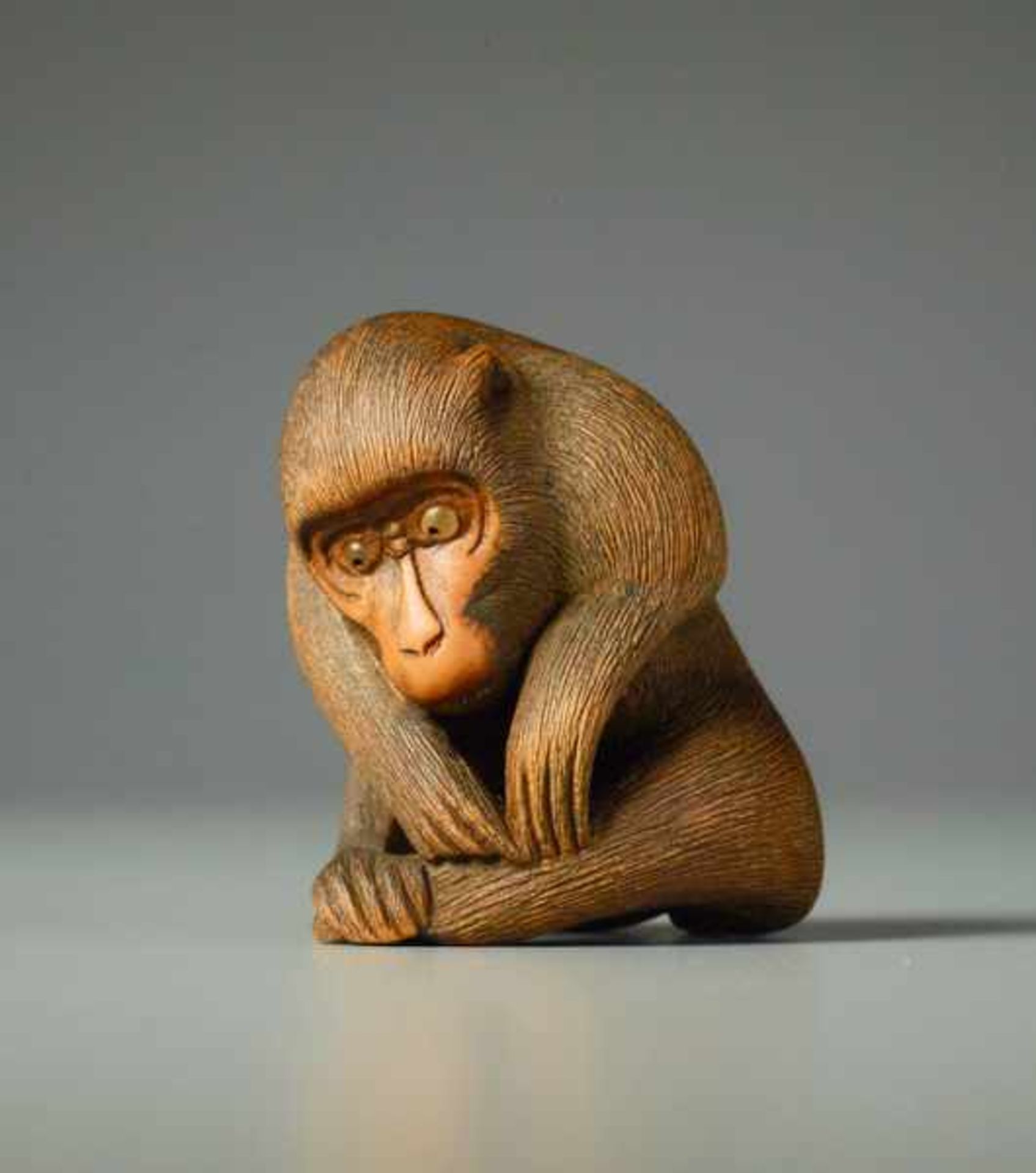 MONKEY BY KOICHI Wood netsuke. Japan, 19th centuryIn this masterfully crafted netsuke, the