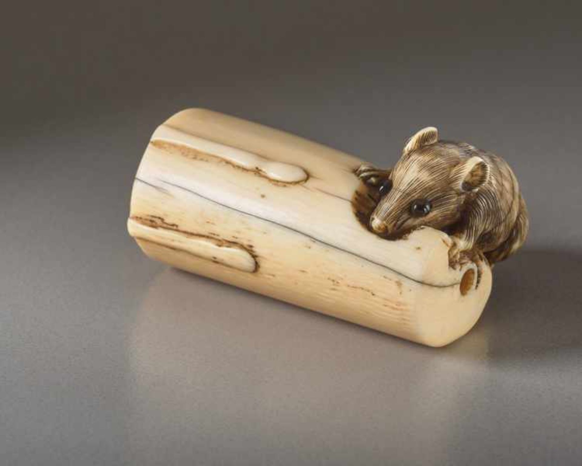 AN IVORY NETSUKE OF A RAT AND CANDLE Ivory netsuke. Japan, 18th or early 19th centuryThe rat, or