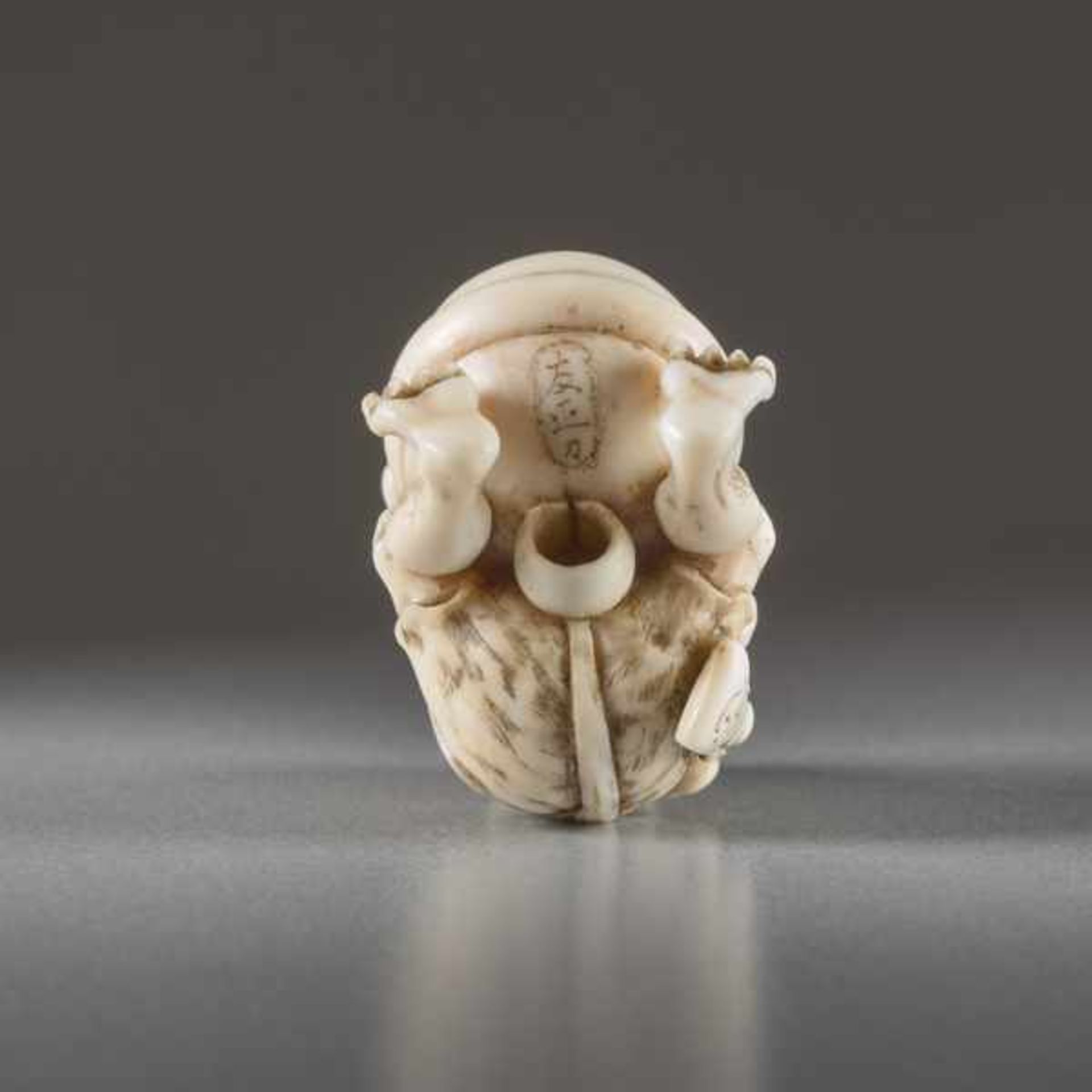 IVORY NETSUKE BY TOMOMASA OF AN ONI Ivory netsuke. Japan, mid-19th centuryA very humorous - Image 6 of 6