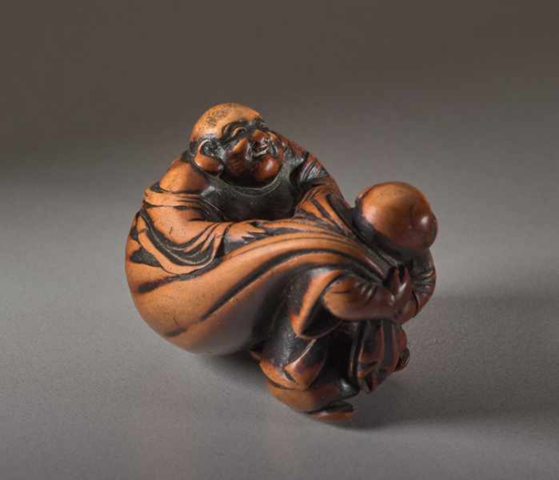 A WOOD NETSUKE OF HOTEI Wood netsuke. Japan, 19th centuryThe ever-laughing Hotei, the most popular - Image 2 of 5