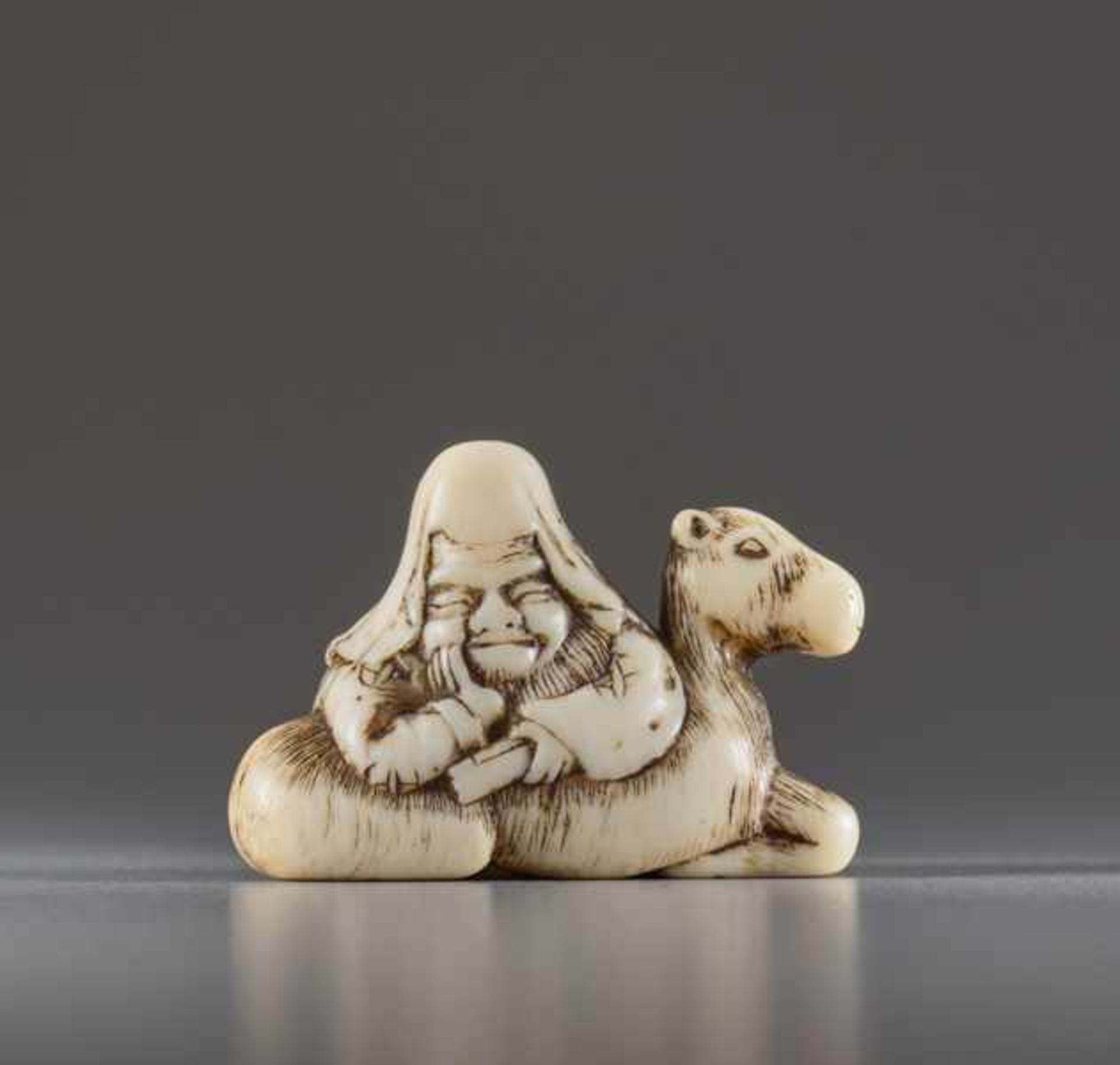 A SMALL IVORY NETSUKE BY RYUO OF FUKUROKUJU Ivory netsuke. Japan, 18th centuryFukurokuju is depicted