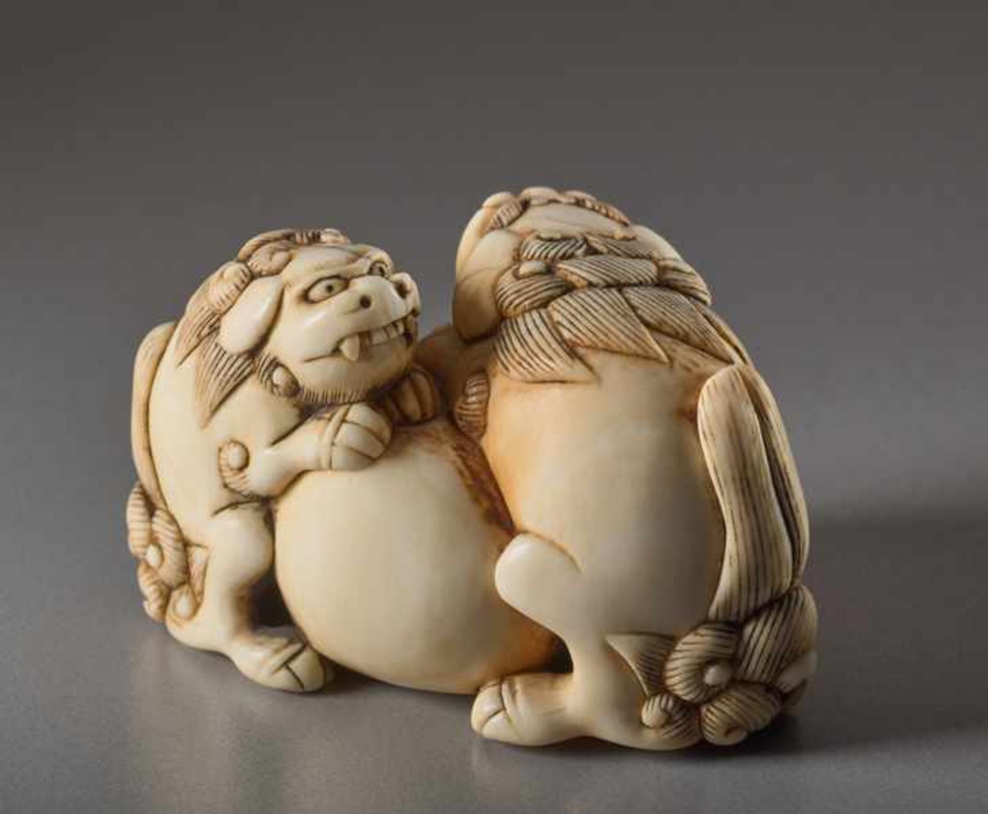 AN IVORY NETSUKE OF TWO SHISHI AND BALL Ivory netsuke. Japan, 18th centuryThe lion dog has a movable - Image 2 of 6