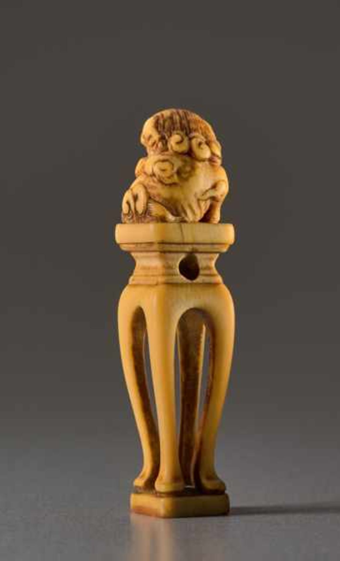 AN IVORY NETSUKE OF A SHISHI ON A PEDESTAL Ivory netsuke. Japan, 19th centuryA very unusually shaped - Image 4 of 5