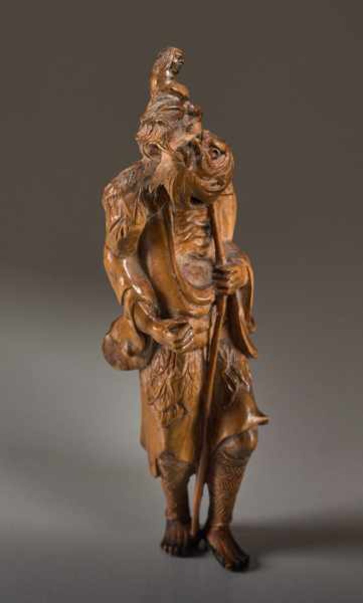 A TALL WOOD NETSUKE OF TEKKAI SENNIN Wood netsuke. Japan, 19th centuryThe immortal with his iron - Image 2 of 8