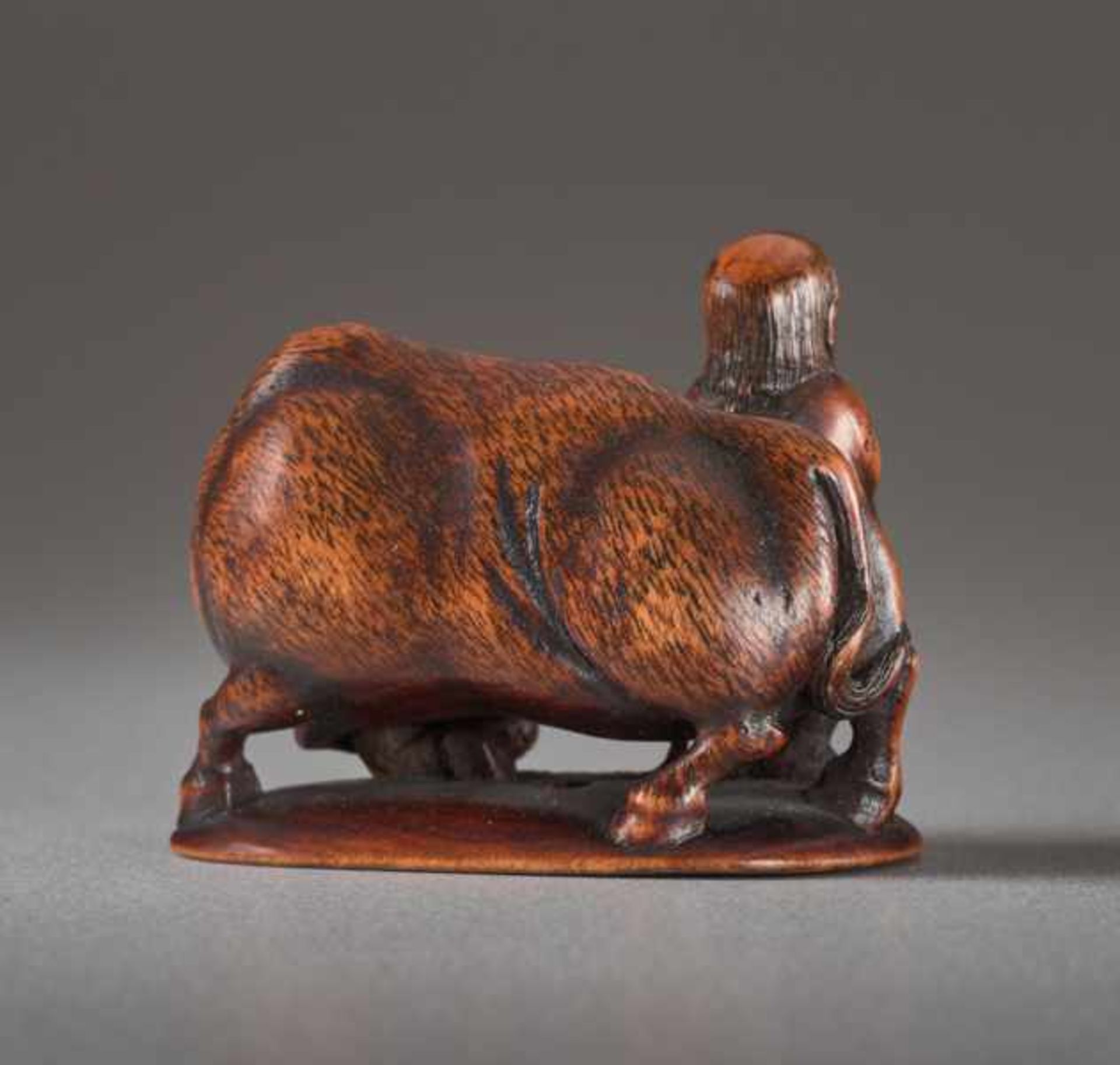 A WOOD NETSUKE BY MINKOKU OF A BOY AND OX Wood netsuke. Japan, 19th centuryA brawny ox with curved - Image 4 of 5