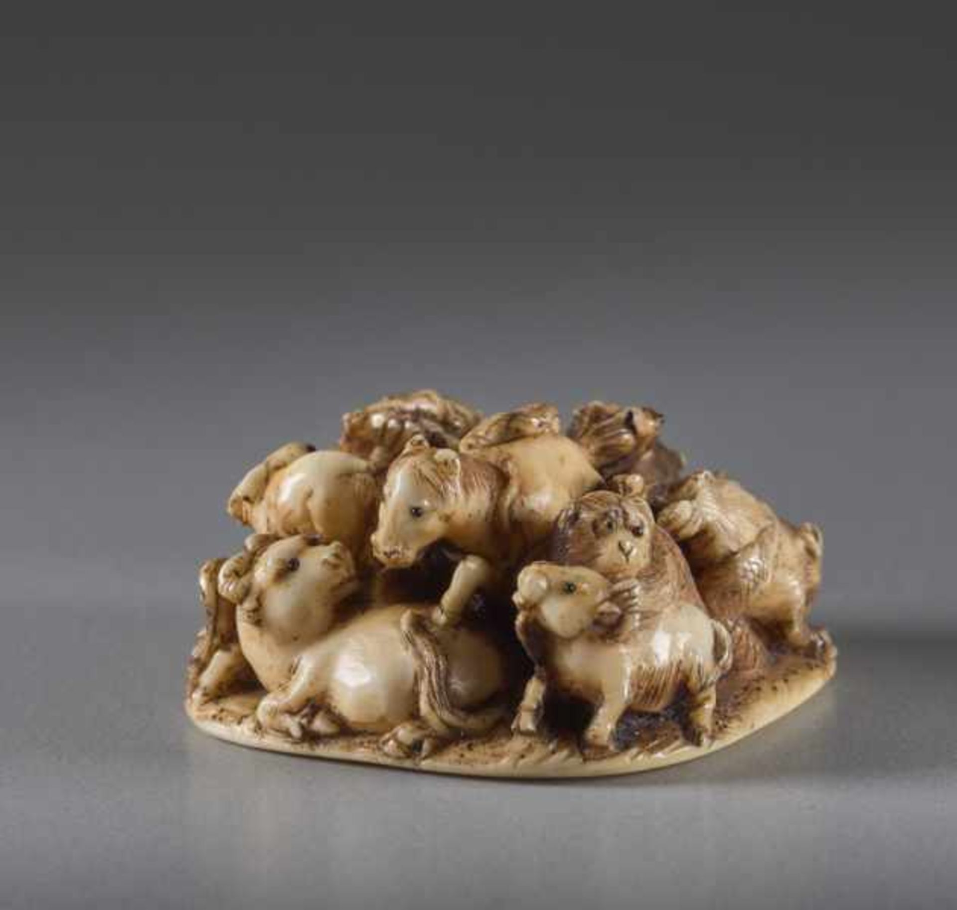 AN IVORY NETSUKE OF THE ZODIAC BY MASAMITSU Ivory netsuke. Japan, Meiji periodOf compact design,