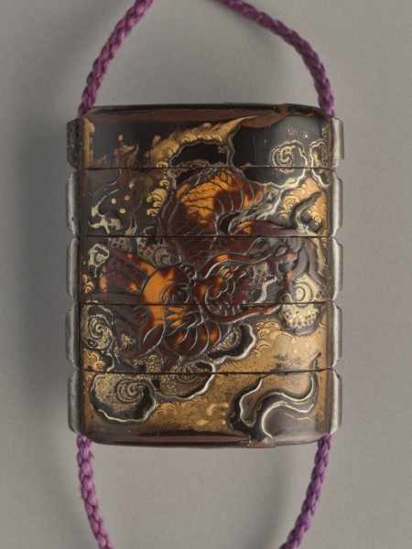 A THREE CASE LACQUER AND GOLD INRO OF A CELESTIAL DRAGON Lacquer, horn and gold inro. Japan, late