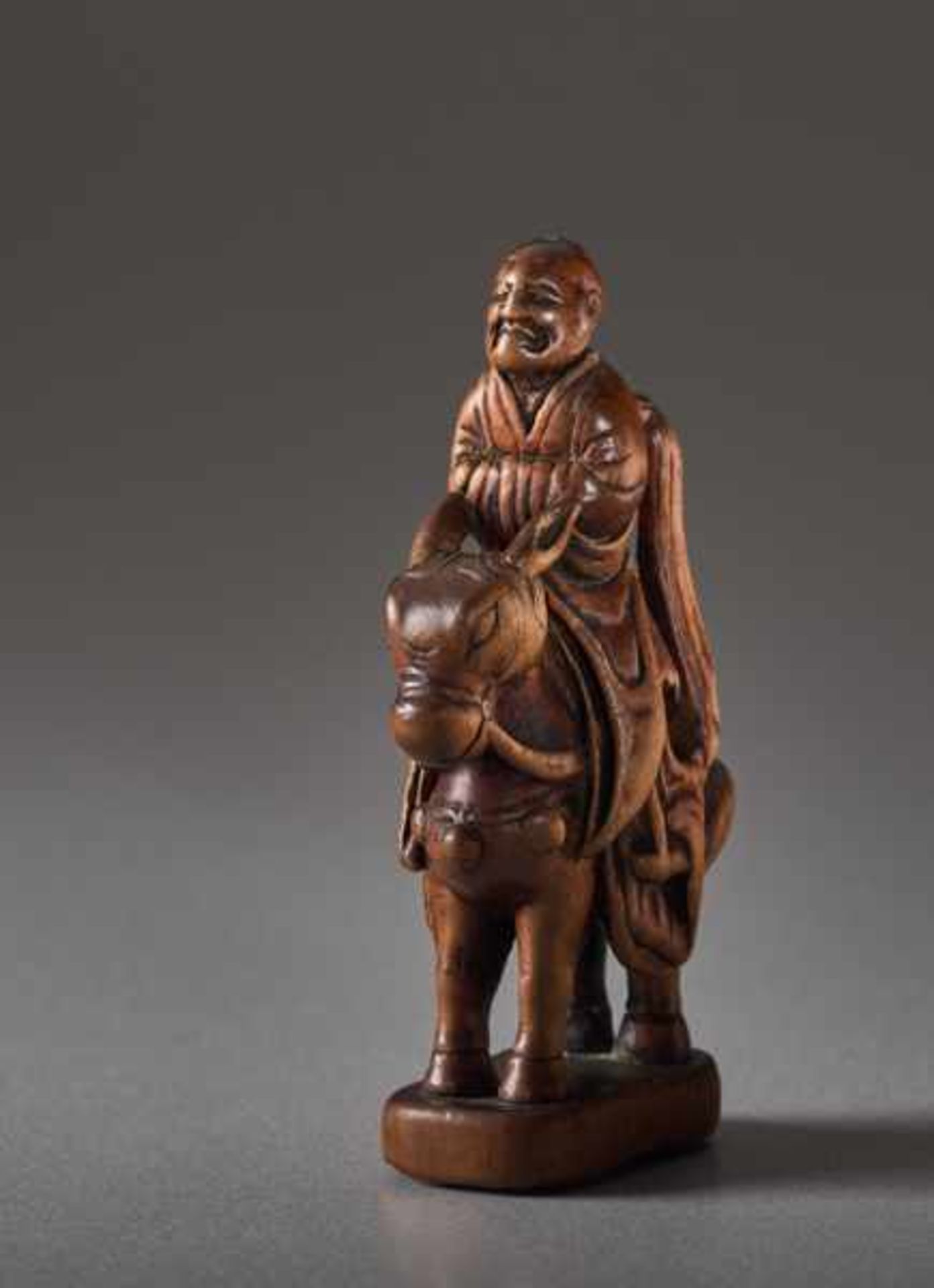 A WOOD NETSUKE OF TOBA SEATED ON HIS MULE Wood netsuke. Japan, 19th centuryToba is a historic