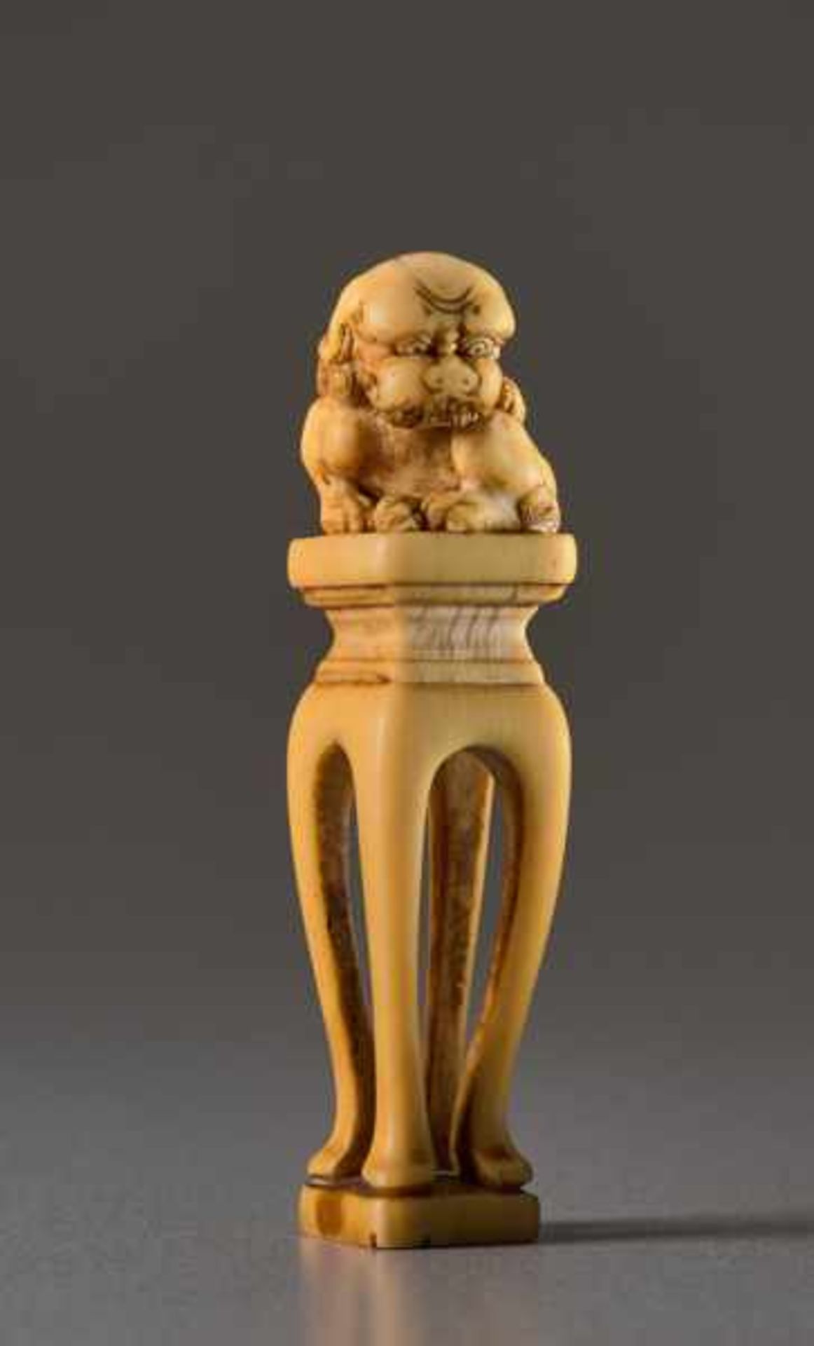 AN IVORY NETSUKE OF A SHISHI ON A PEDESTAL Ivory netsuke. Japan, 19th centuryA very unusually shaped - Image 2 of 5