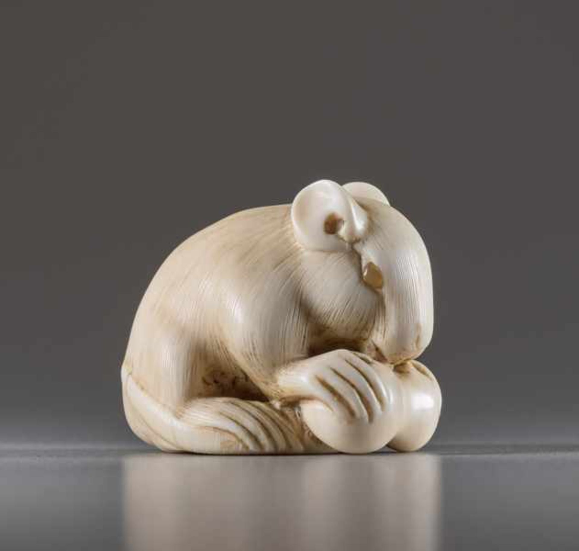 AN IVORY NETSUKE BY IKKO OF A RAT WITH DOUBLE GOURD Ivory netsuke. Japan, 19th centuryA very