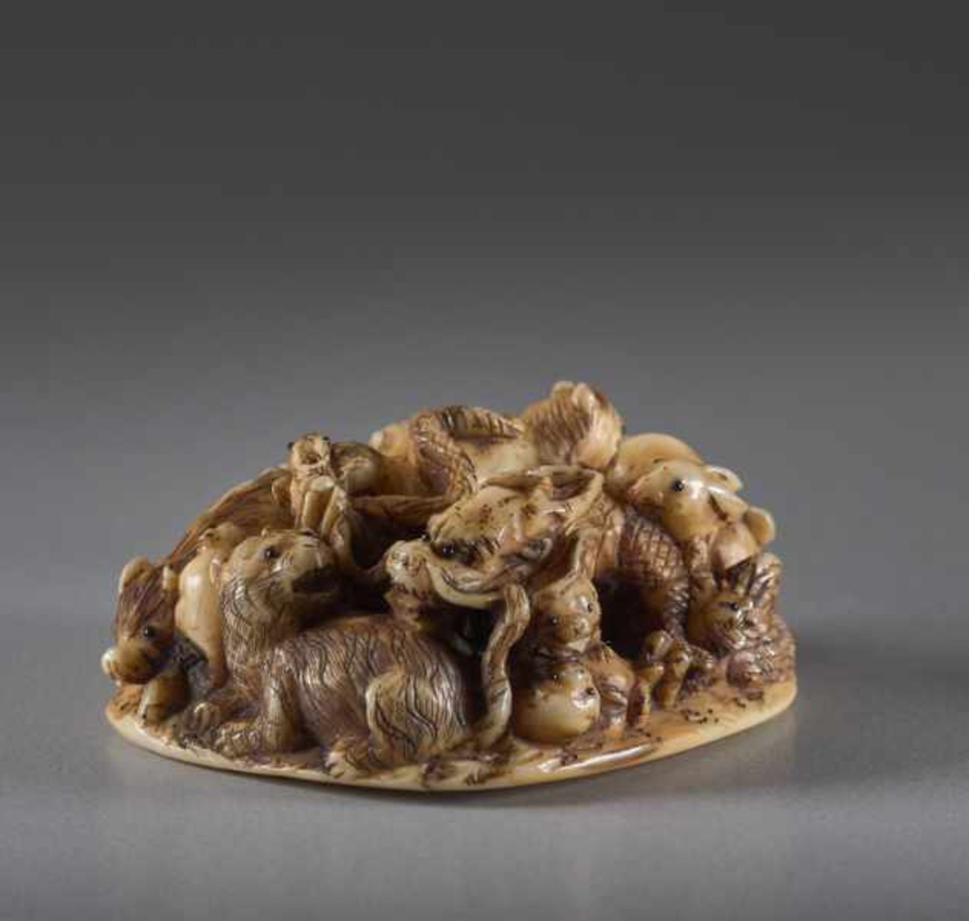 AN IVORY NETSUKE OF THE ZODIAC BY MASAMITSU Ivory netsuke. Japan, Meiji periodOf compact design, - Image 2 of 5