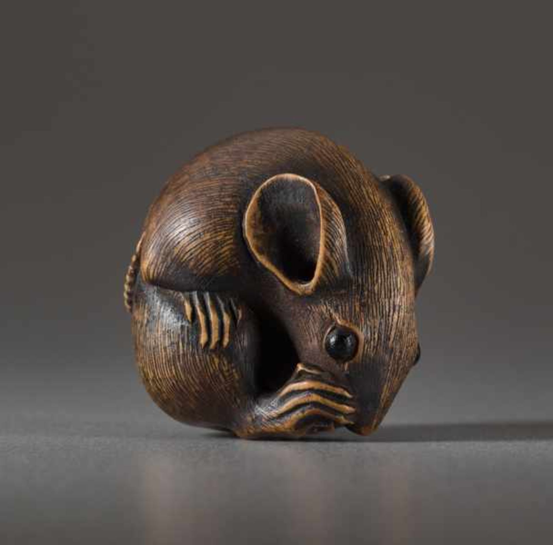 A WOOD NETSUKE BY MASANAO OF A RAT Wood netsuke. Japan, 19th centuryThe famous ‘Masanao rat’ has