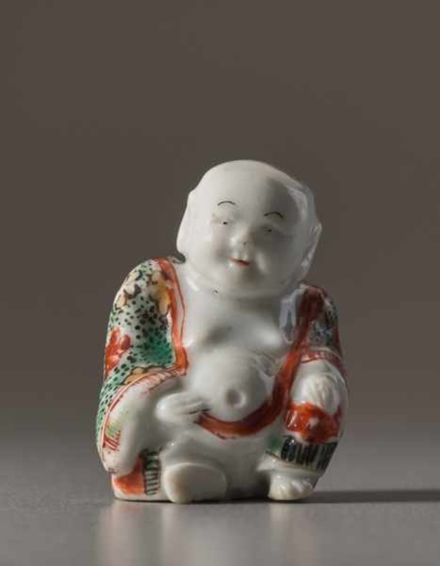 A PORCELAIN NETSUKE OF HOTEI Porcelain netsuke with enamel colors. Japan, Meiji periodA very fine