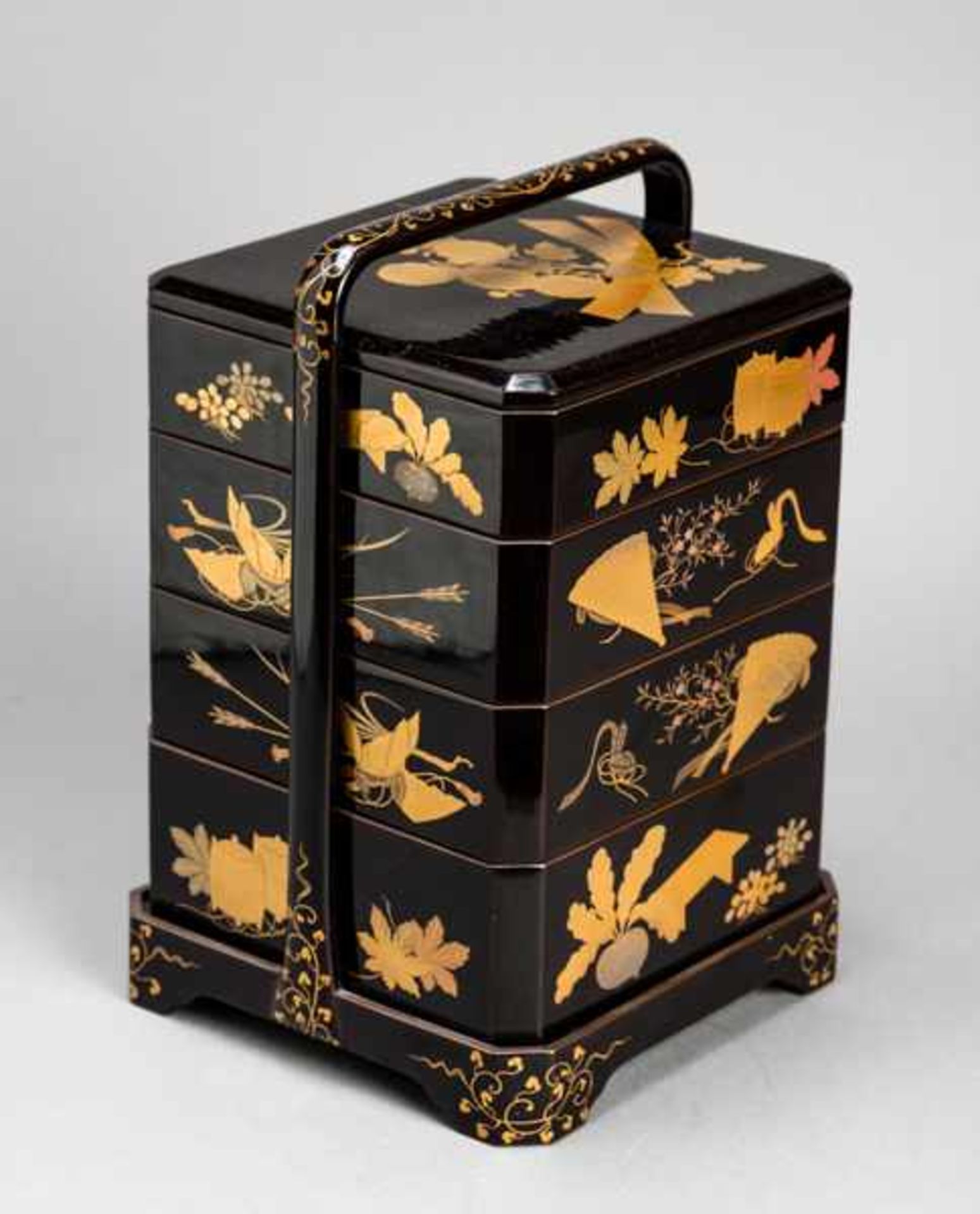 A BLACK LACQUER FOUR-TIER JUBAKO (CAKE BOX) AND COVER WITH A PORTABLE CASE Wood and lacquer.