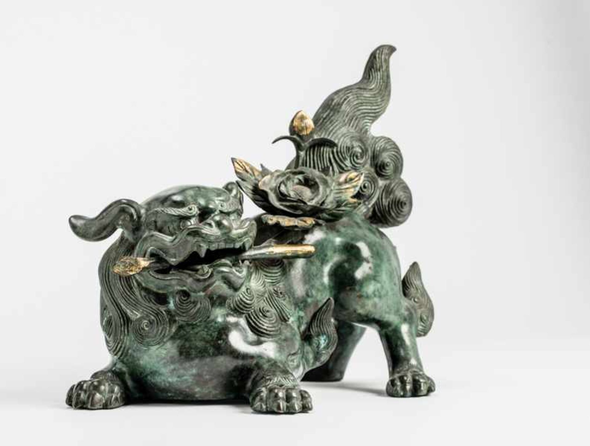 A BRONZE SHISHI Bronze with gilding. Japan, 19th centuryOf beautiful greenish patina, the former