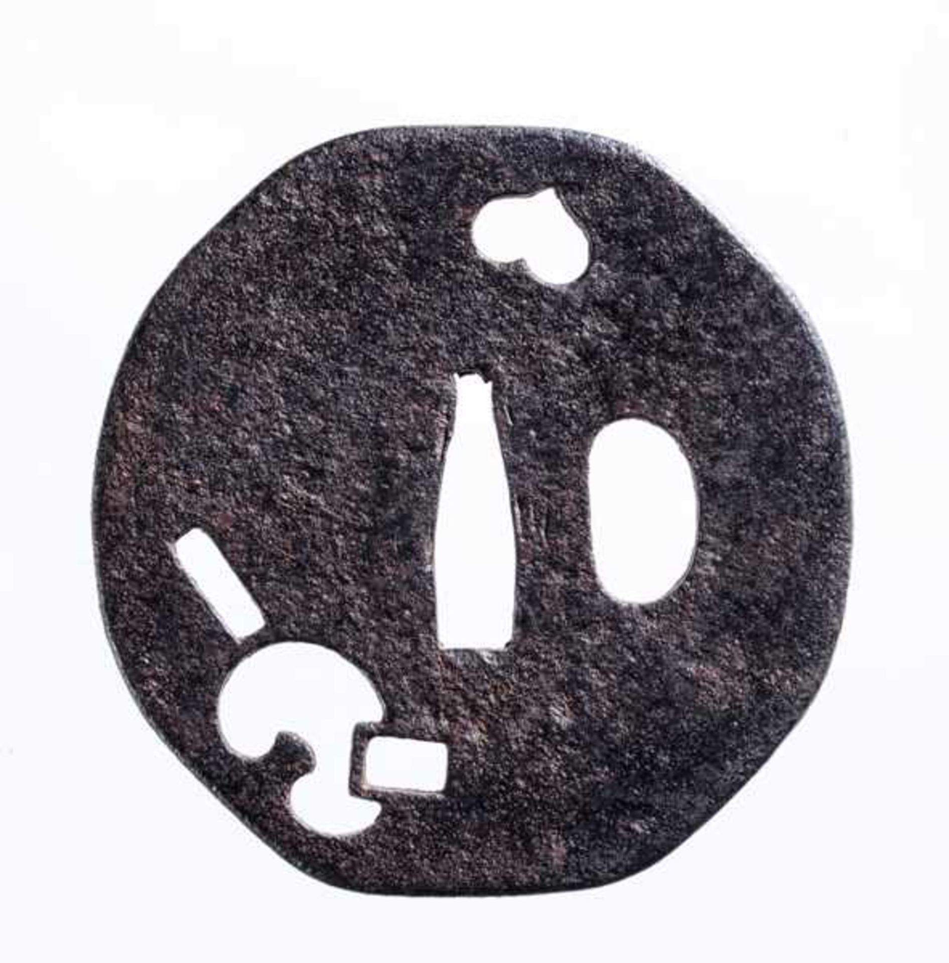 AN IRON SUKASHI TSUBA Iron. Japan, Muromachi period or afterYatsu mokko, a slight octagon/circular