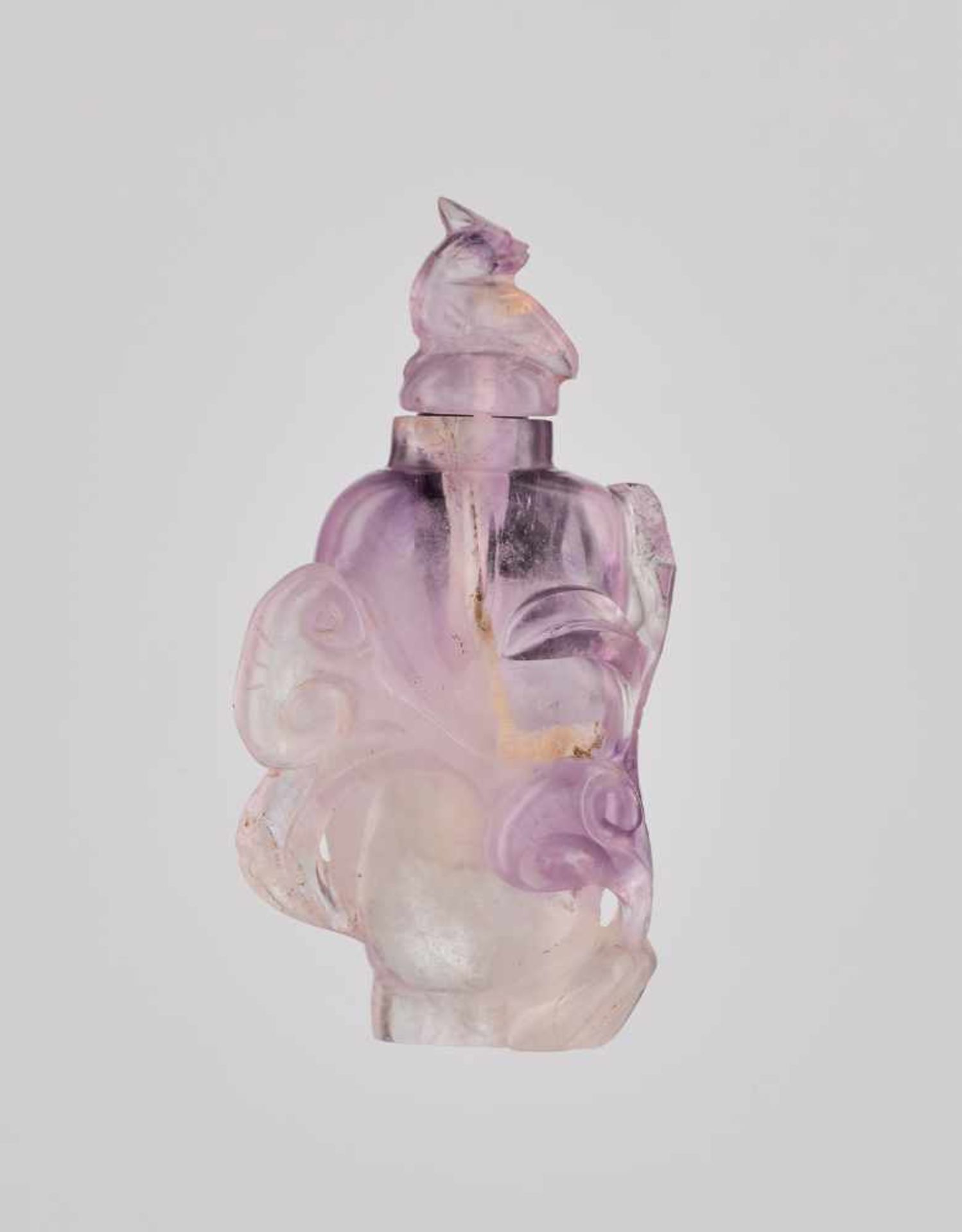 AN AMETHYST ‘LINGZHI’ SNUFF BOTTLE Carved amethyst of with color varying from white crystal to