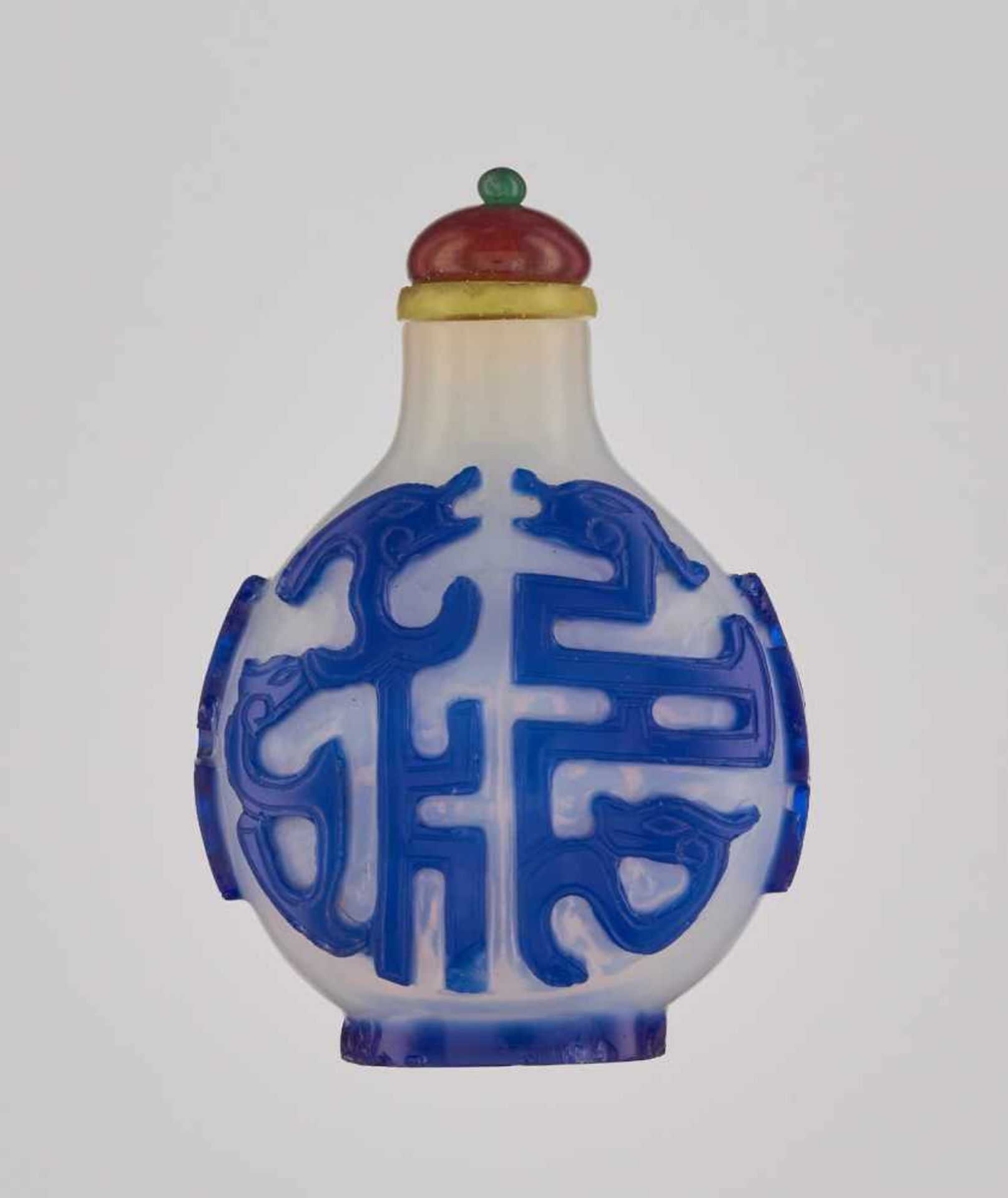 A SAPPHIRE-BLUE ON MILKY-WHITE OVERLAY ‘KUILONG’ GLASS SNUFF BOTTLE Glass, with incised overlay