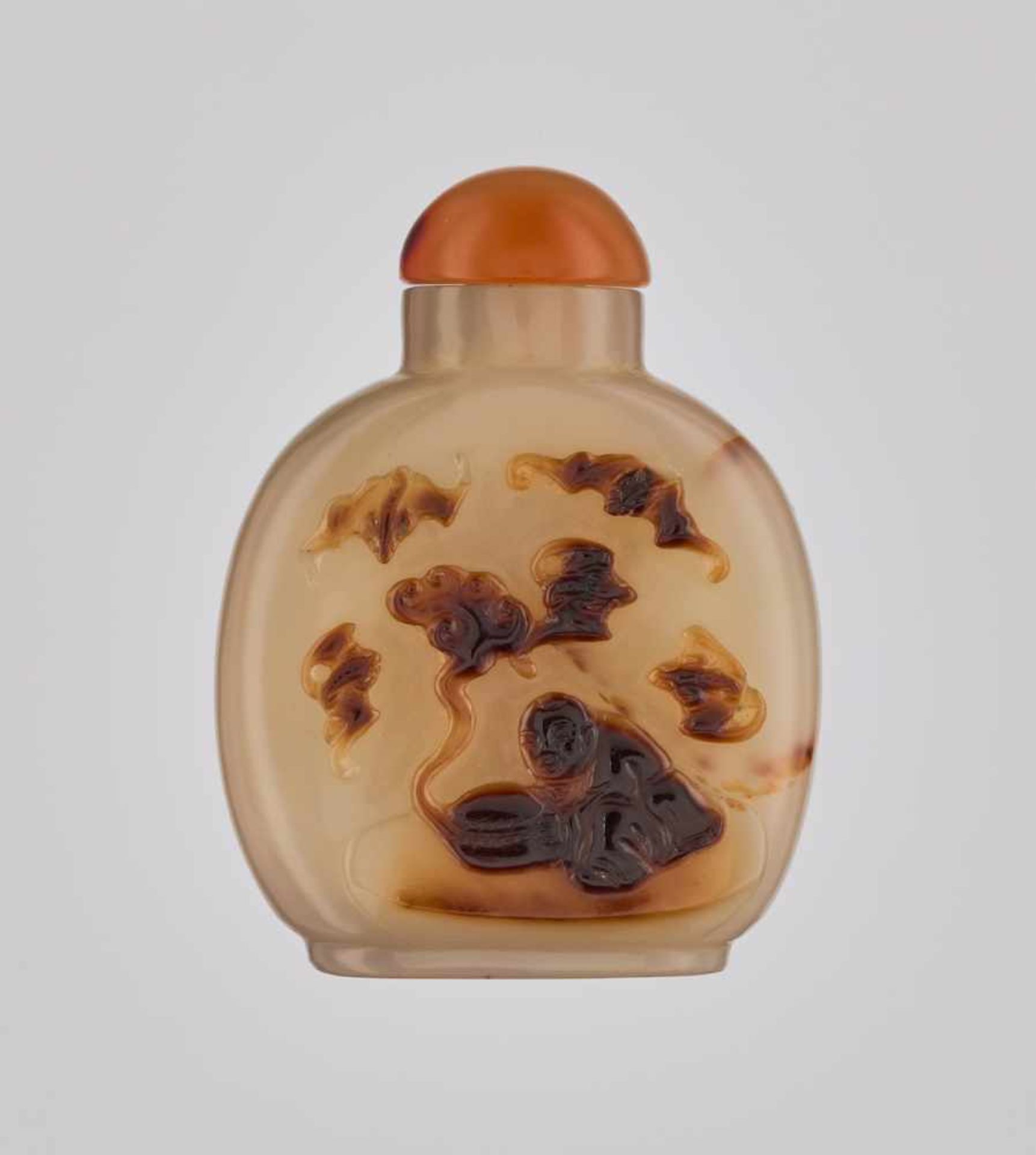 A ‘BOY AND FIVE BATS’ SHADOW AGATE SNUFF BOTTLE, QING DYNASTY Honey colored, translucent agate of