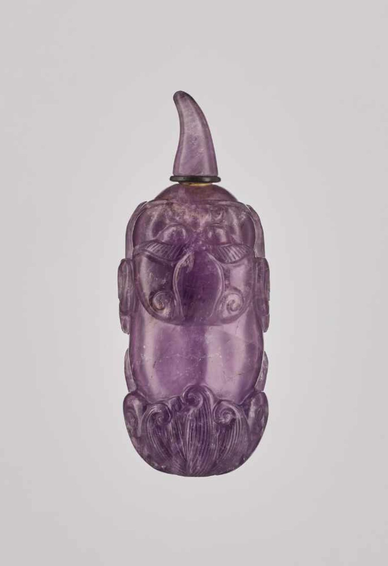 A CARVED AMETHYST AND BROWN CRYSTAL 'BUDDHIST LION' SNUFF BOTTLE Crystal (amethyst and brown