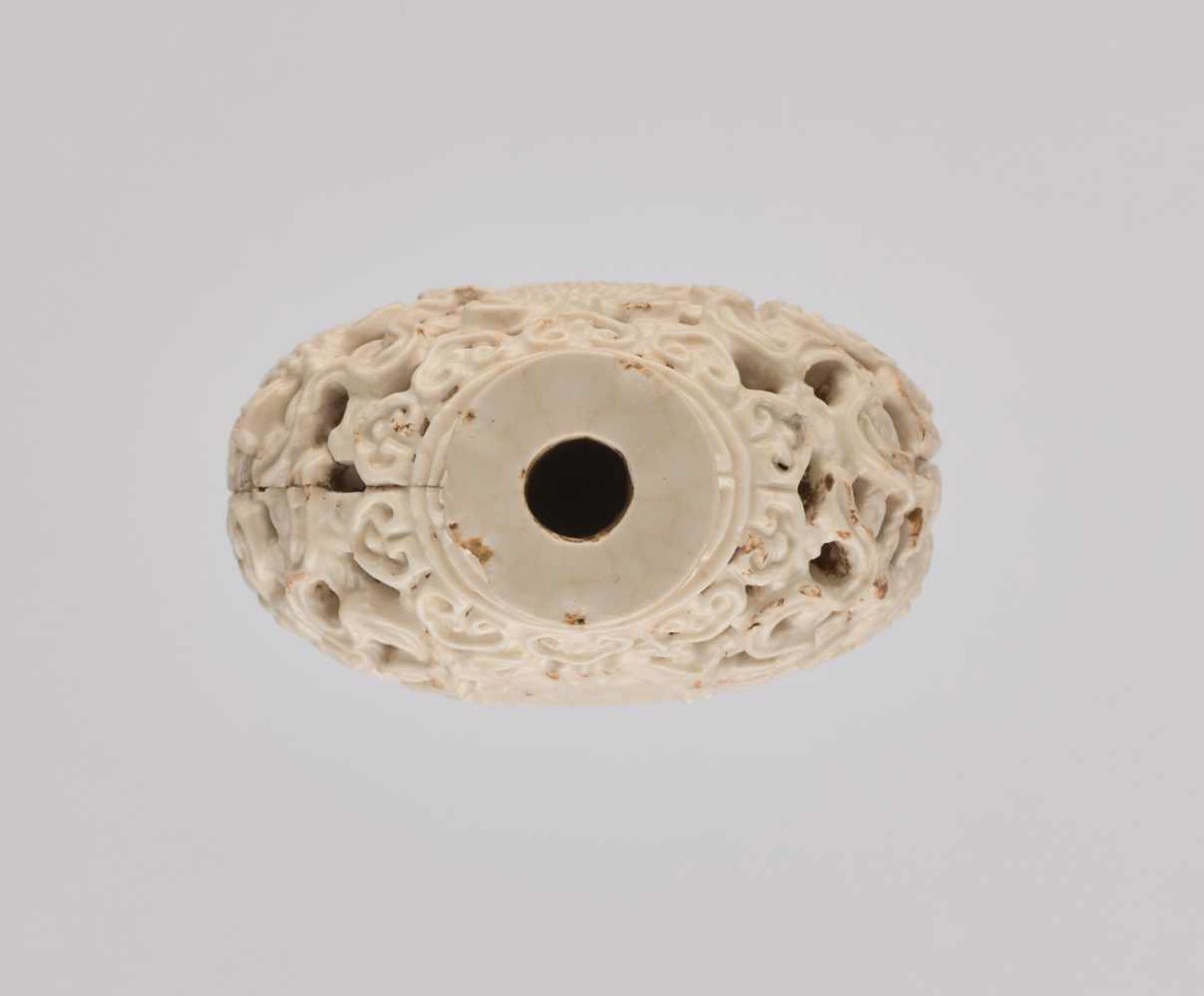 A RETICULATED WHITE PORCELAIN 'BA JIXIANG' SNUFF BOTTLE Crackled creamy-white glaze on molded and - Image 5 of 6