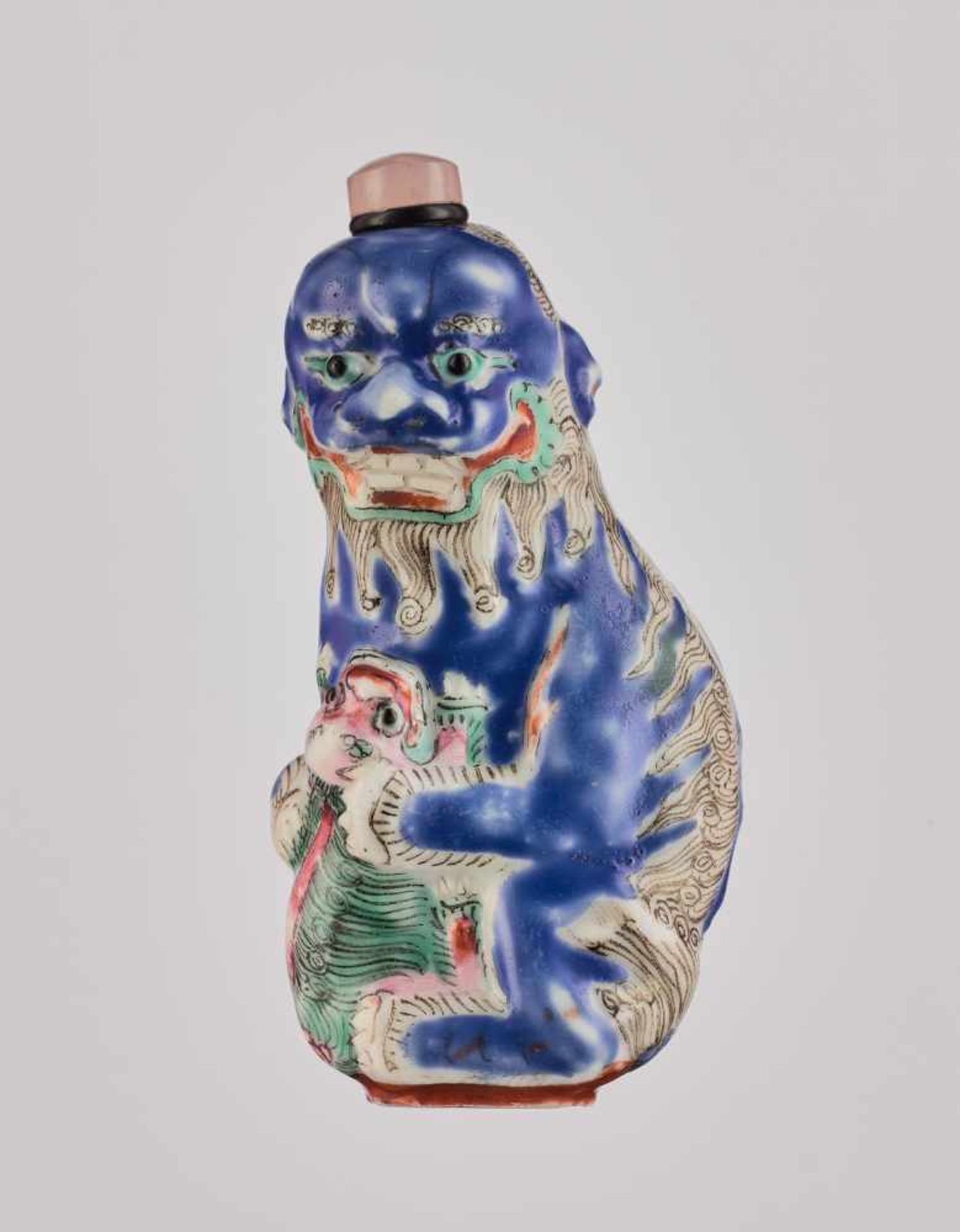 A MOLDED PORCELAIN 'BUDDHIST LION AND CUB' SNUFF BOTTLE, QING DYNASTY Molded and carved porcelain