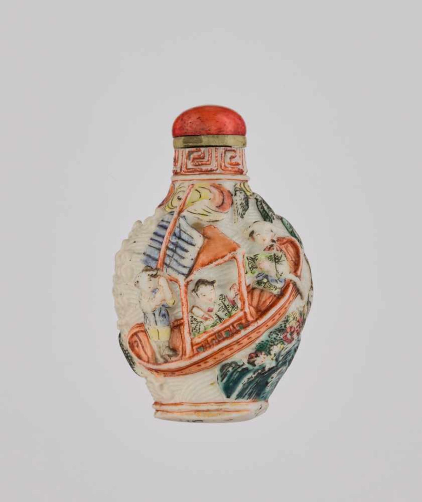 A FAMILLE ROSE MOLDED PORCELAIN SNUFF BOTTLE Molded and carved porcelain in high relief, painted