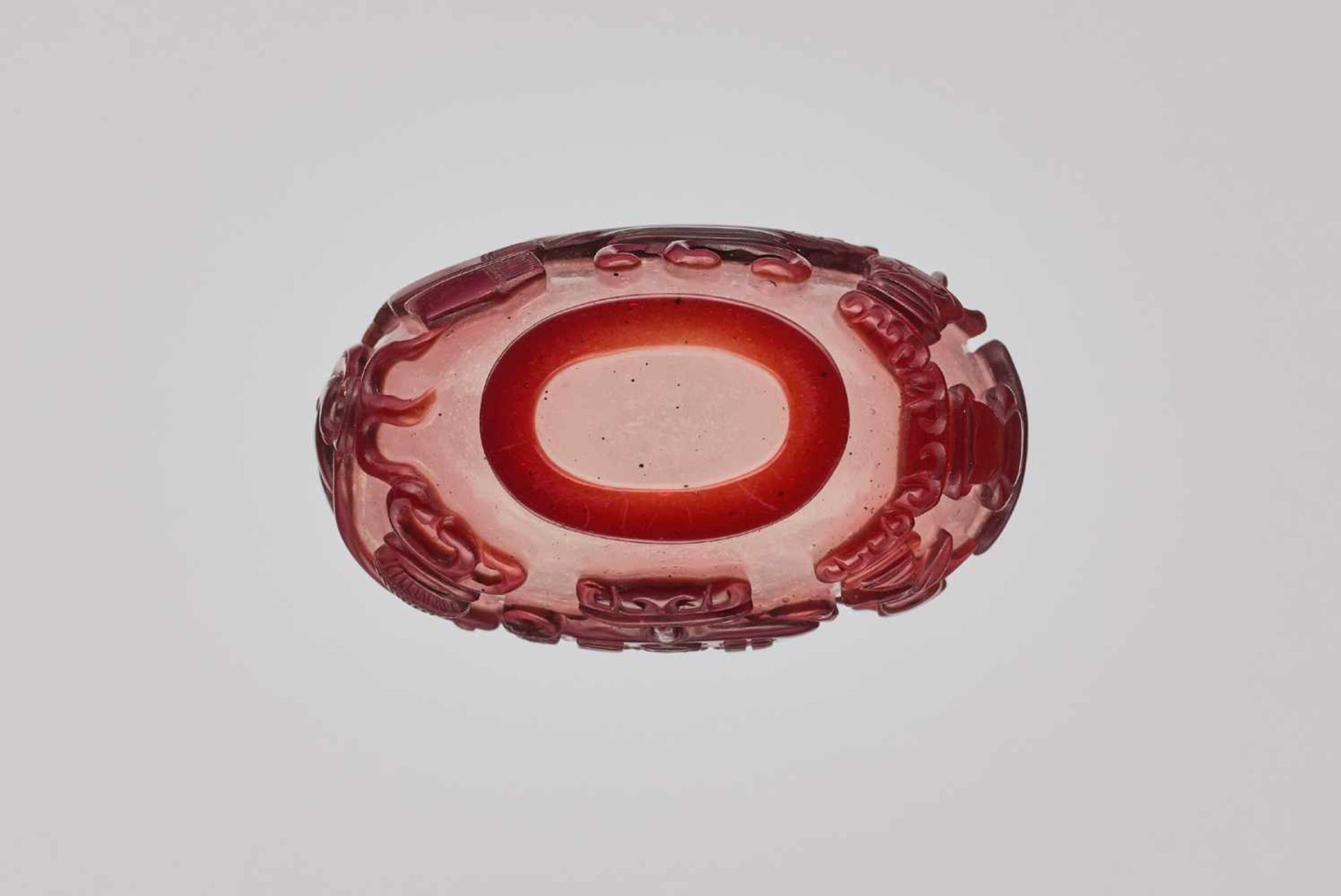 A RUBY-RED OVERLAY WHITE GLASS 'AUSPICIOUS OBJECTS' SNUFF BOTTLE, QING DYNASTY Carved and incised - Image 6 of 6