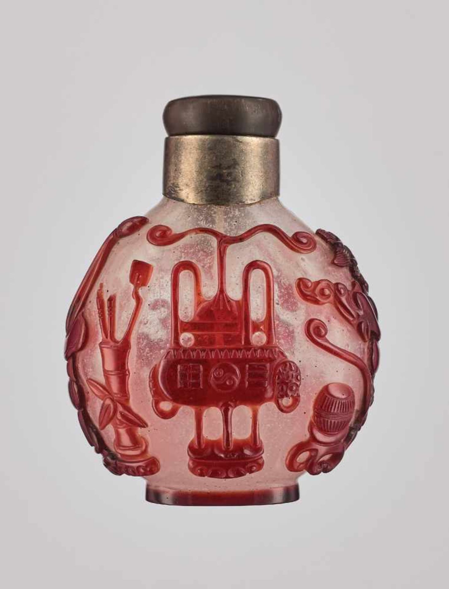 A RUBY-RED OVERLAY WHITE GLASS 'AUSPICIOUS OBJECTS' SNUFF BOTTLE, QING DYNASTY Carved and incised