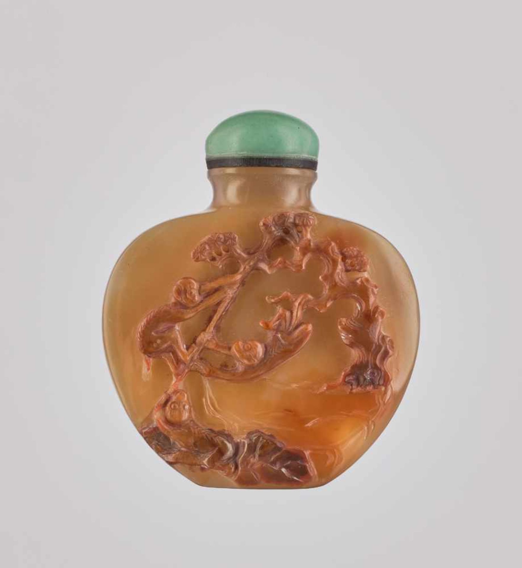 A SHADOW AGATE ‘THREE PLAYFUL MONKEYS’ SNUFF BOOTLE, QING DYNASTY The stone of a semi-translucent,