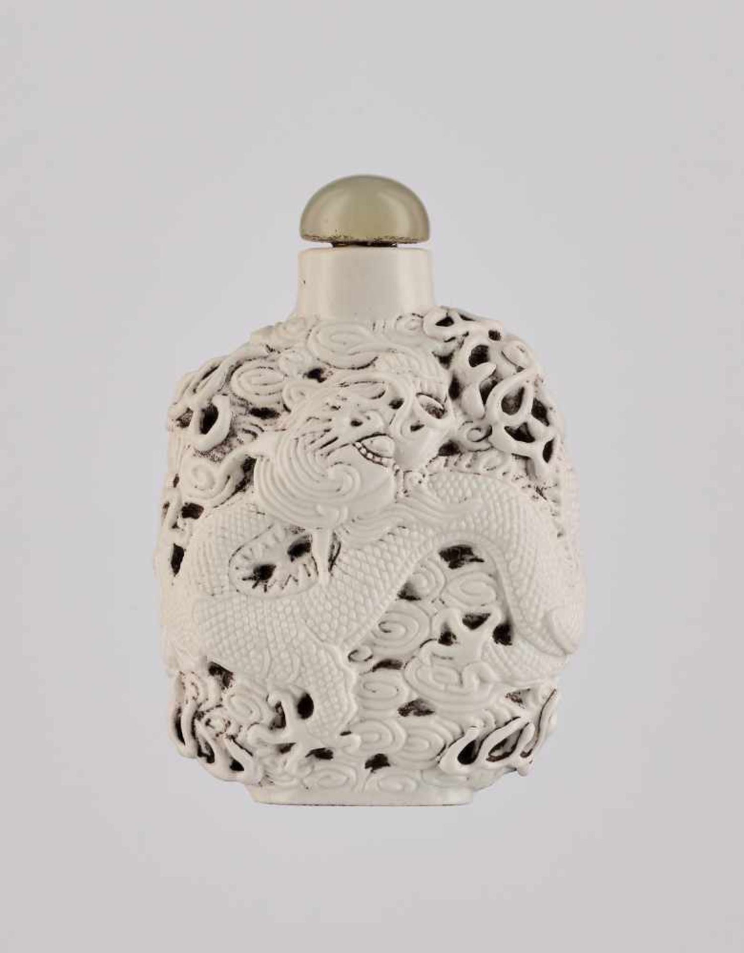 A MOLDED ‘DRAGON’ PORCELAIN SNUFF BOTTLE, DAOGUANG MARK AND PERIOD Molded and carved white porcelain