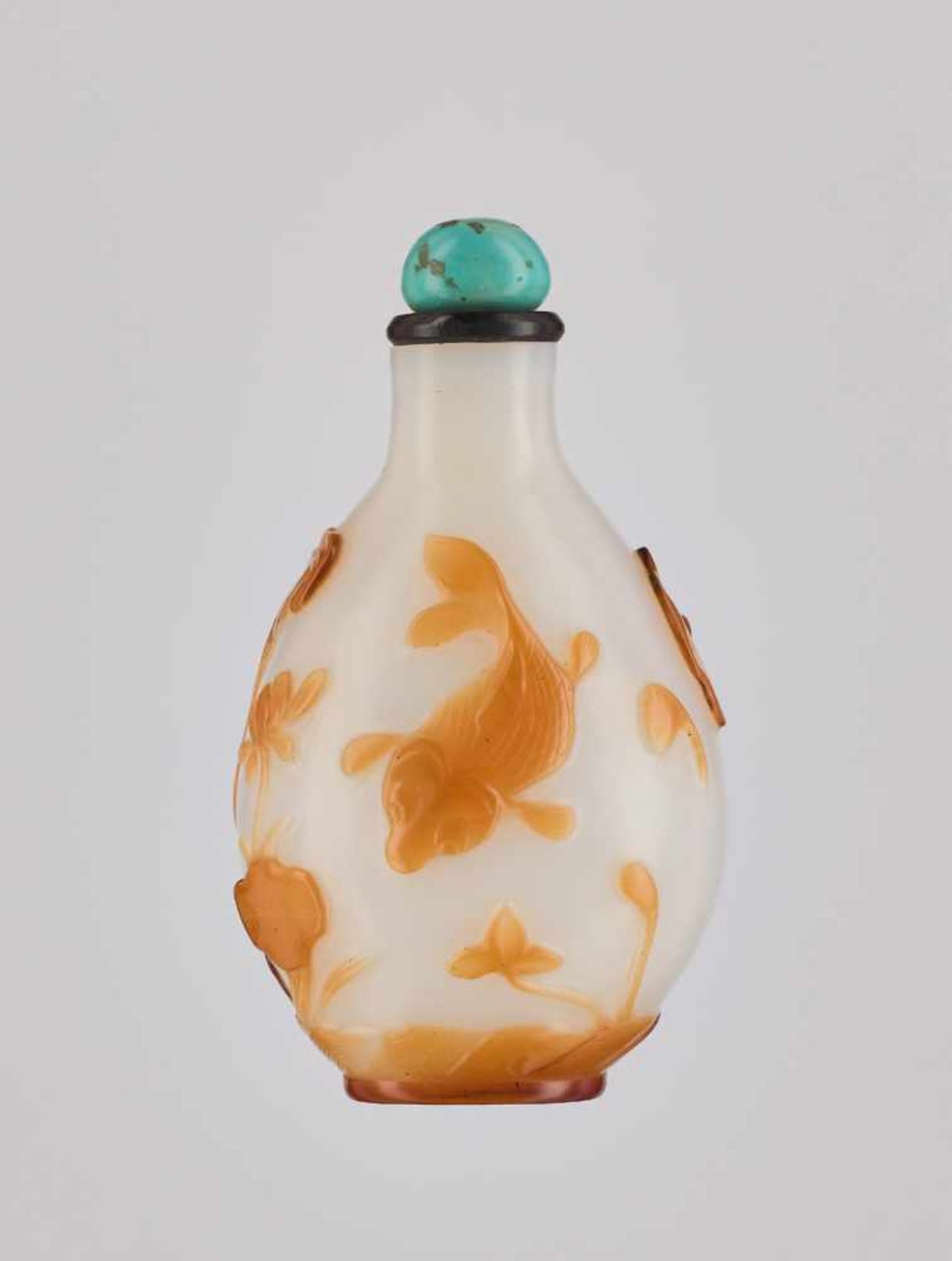 A CARAMEL-YELLOW OVERLAY ‘CARP & LOTUS’ WHITE GLASS SNUFF BOTTLE Carved translucent caramel-yellow