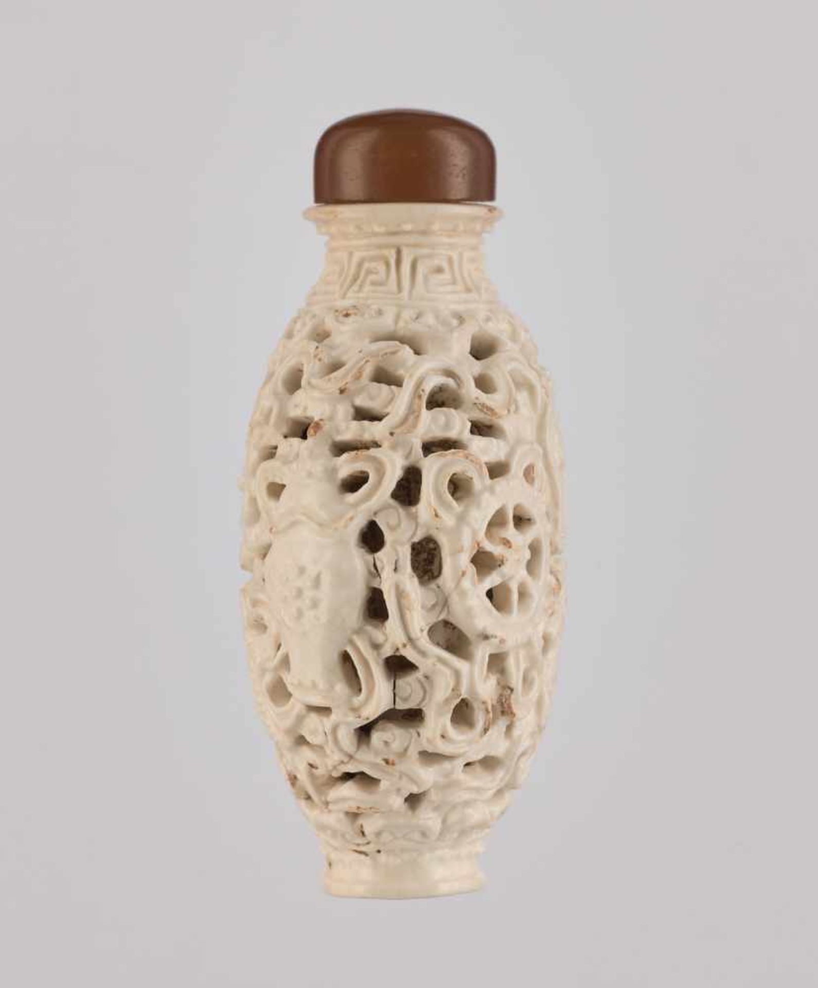 A RETICULATED WHITE PORCELAIN 'BA JIXIANG' SNUFF BOTTLE Crackled creamy-white glaze on molded and - Image 4 of 6