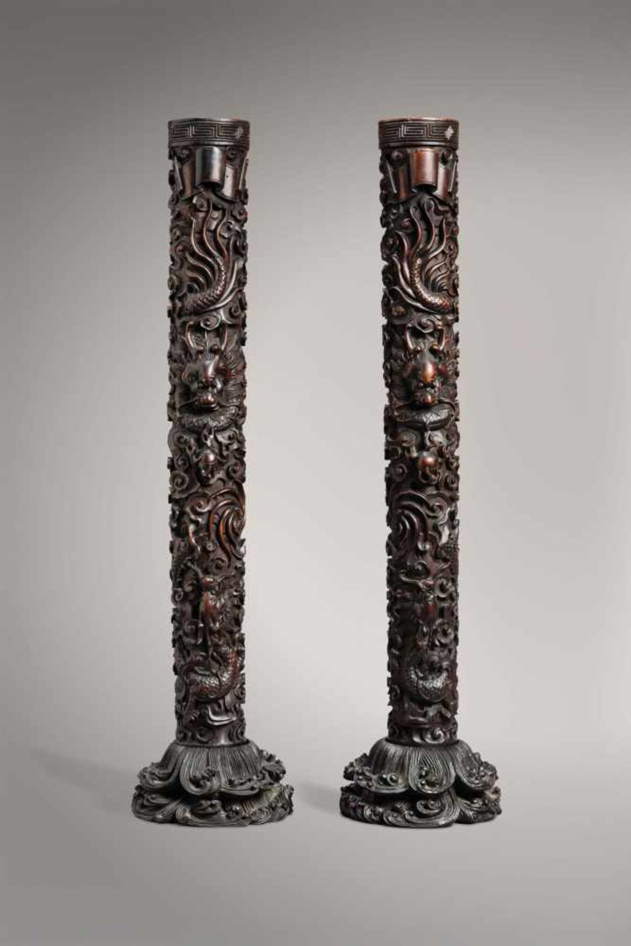 A PAIR OF ZITAN ‘TWO-DRAGON' CANDLESTICKS ON STANDS, QING DYNASTY The Zitan wood with its typical “