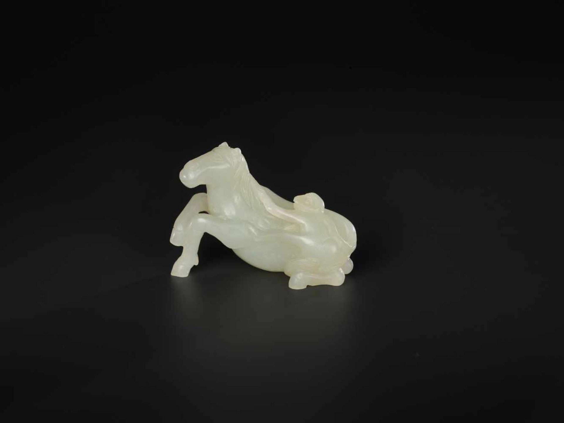 A PALE CELADON 'HORSE AND MONKEY' JADE CARVING, QING DYNASTY, 18TH / 19TH CENTURY The stone of even,
