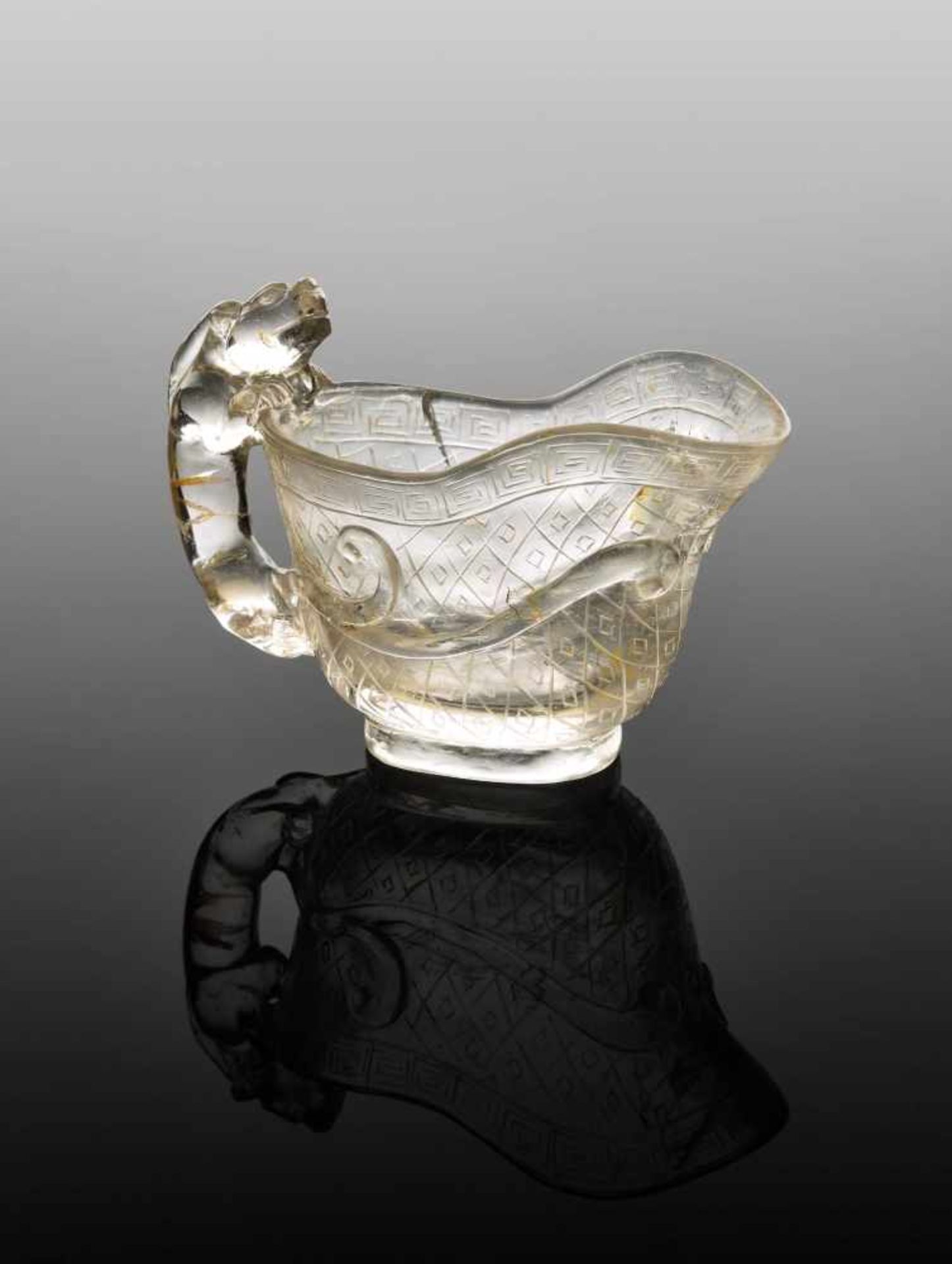 A QING DYNASTY ROCK CRYSTAL LIBATION CUP with CHILONG HANDLE Transparent rock crystal with natural