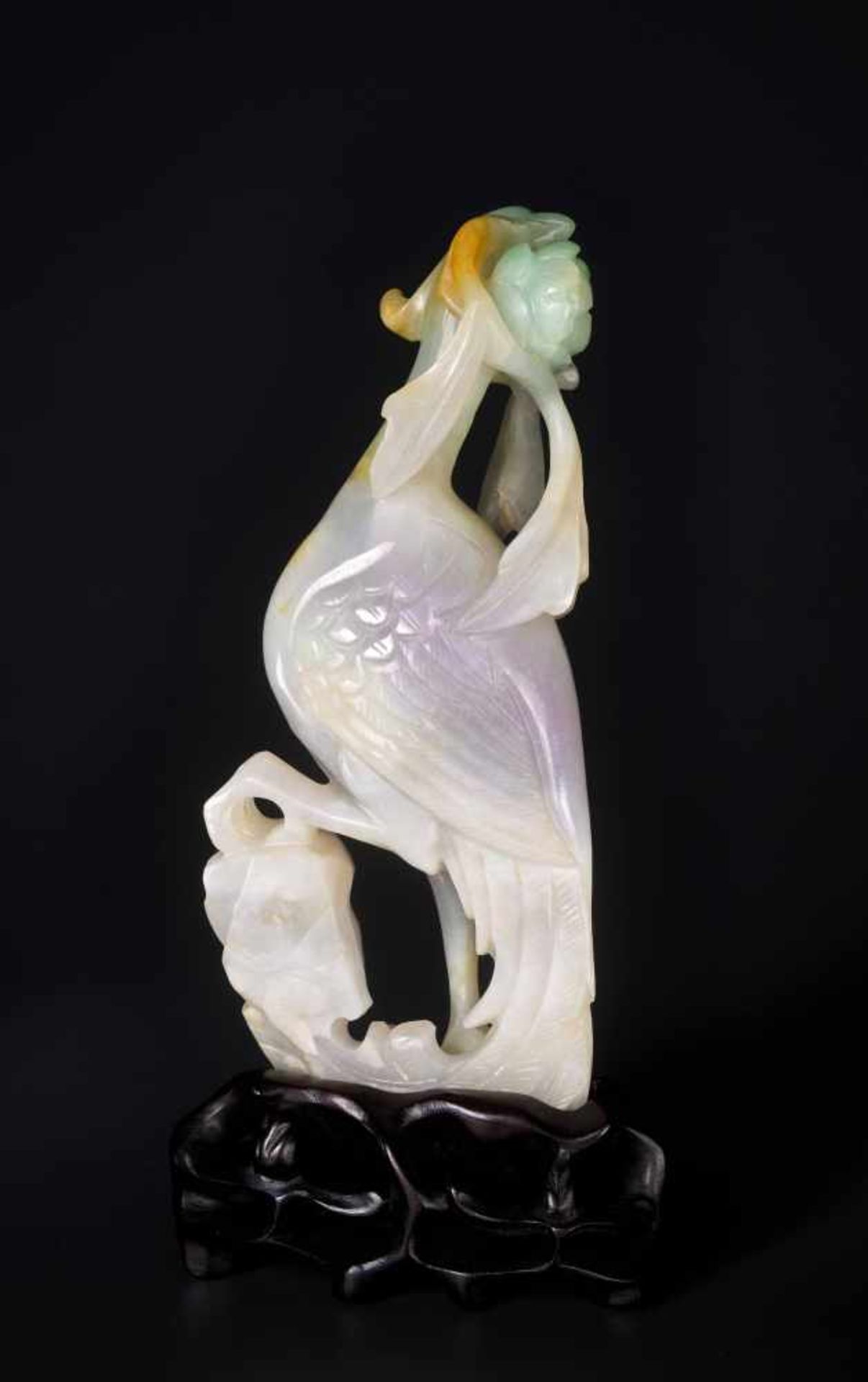 A JADEITE SCULPTURE OF A PHEONIX WITH PEONY, 1900s Jadeite in white, lilac, russet, and green hues