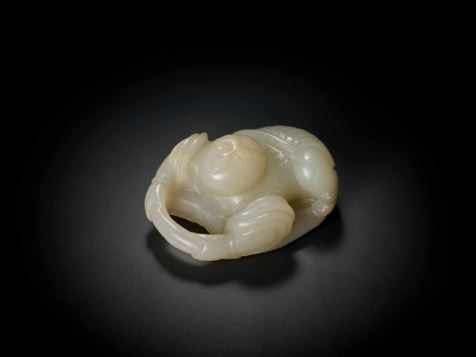 AN 18TH CENTURY JADE ‘BOY AND LOTUS’ CARVING Pale celadon jade of even color and translucent