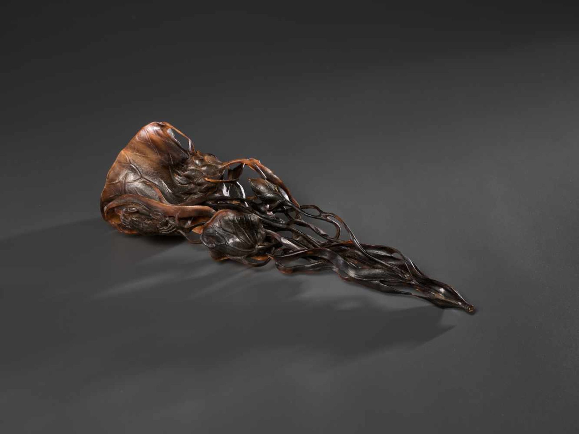 AN 18TH CENTURY RETICULATED FULL TIP RHINOCEROS ‘LOTUS’ CUP Rhinoceros horn in a deep brown to light
