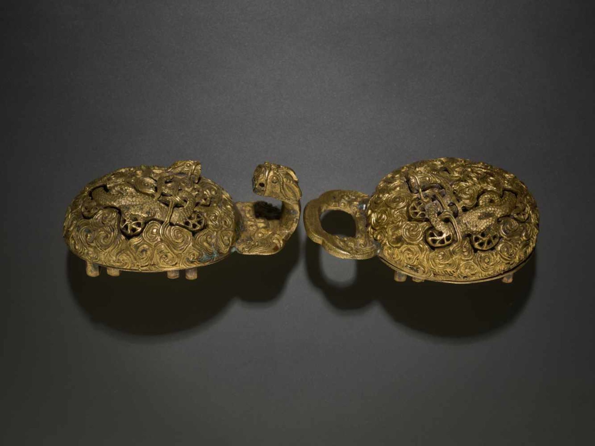 A RETICULATED BRONZE ‘DRAGON’ BELT BUCKLE, QING DYNASTY, 18TH CENTURY Bronze with original