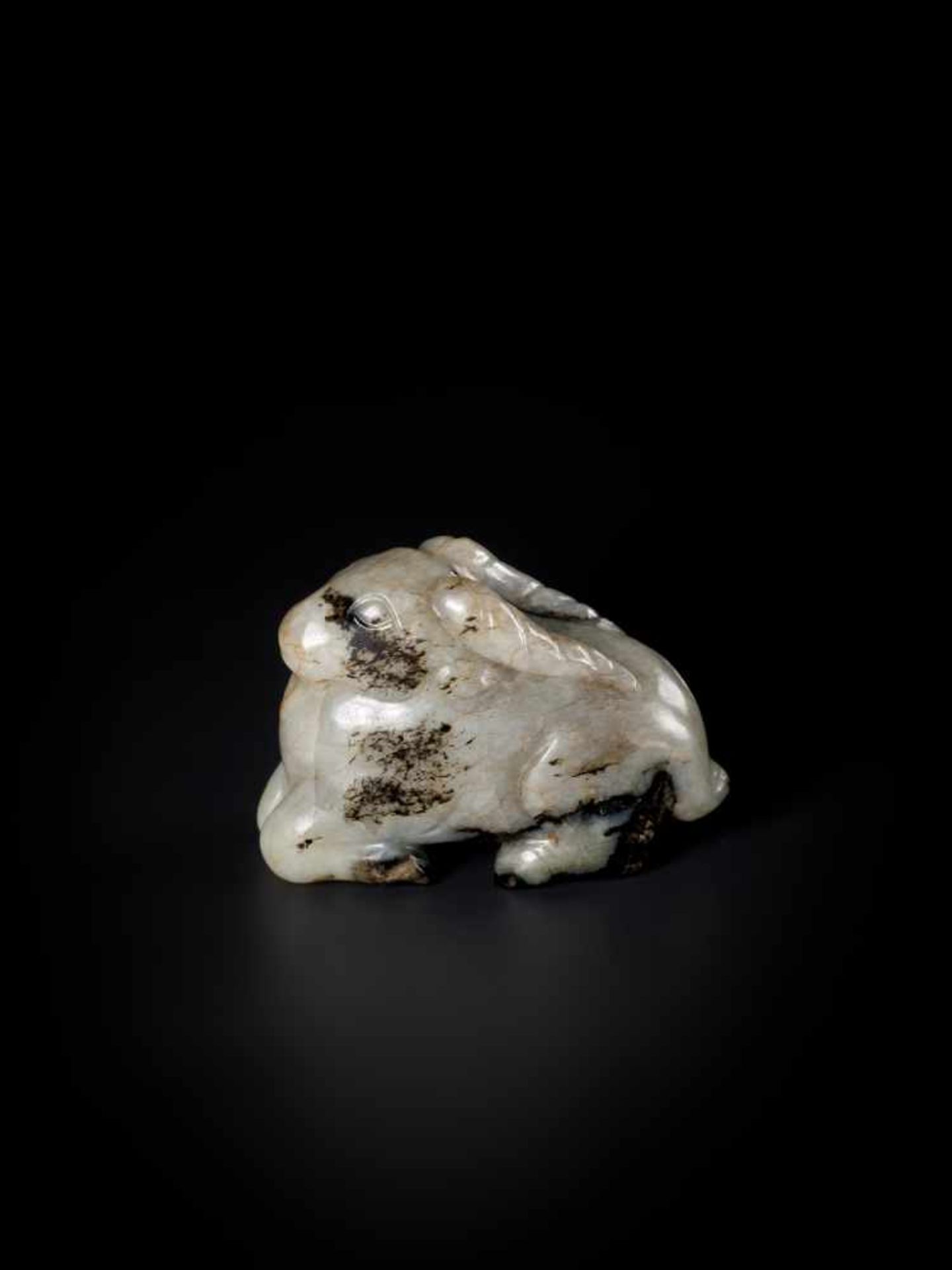 A MING DYNASTY MOTTLED JADE CARVING OF A RAM WITH LINGZHI Celadon, brown and black mottled jade,