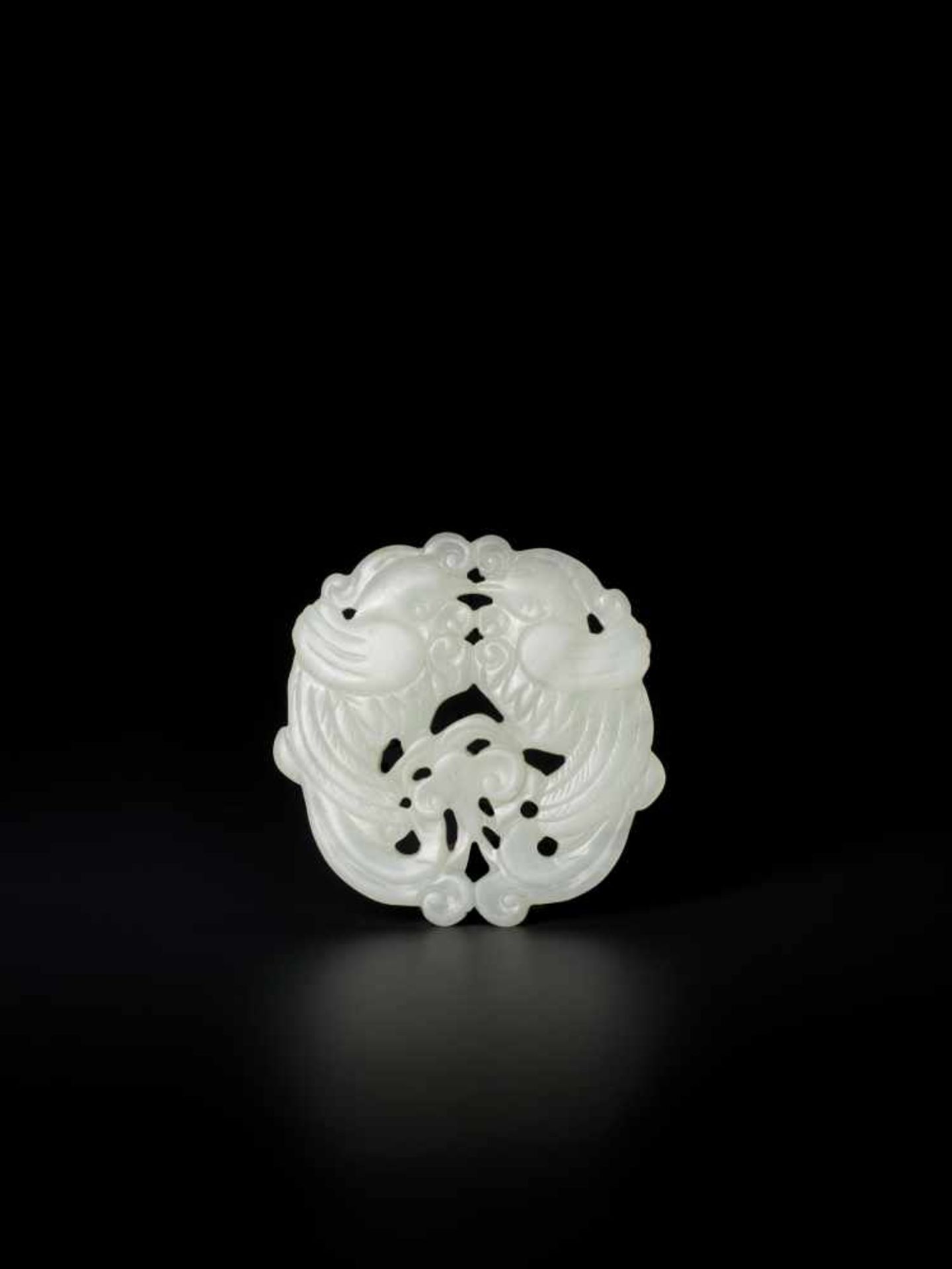 A WHITE JADE QING DYNASTY ‘DOUBLE PHOENIX’ PENDANT White color jade of an even tone, smooth