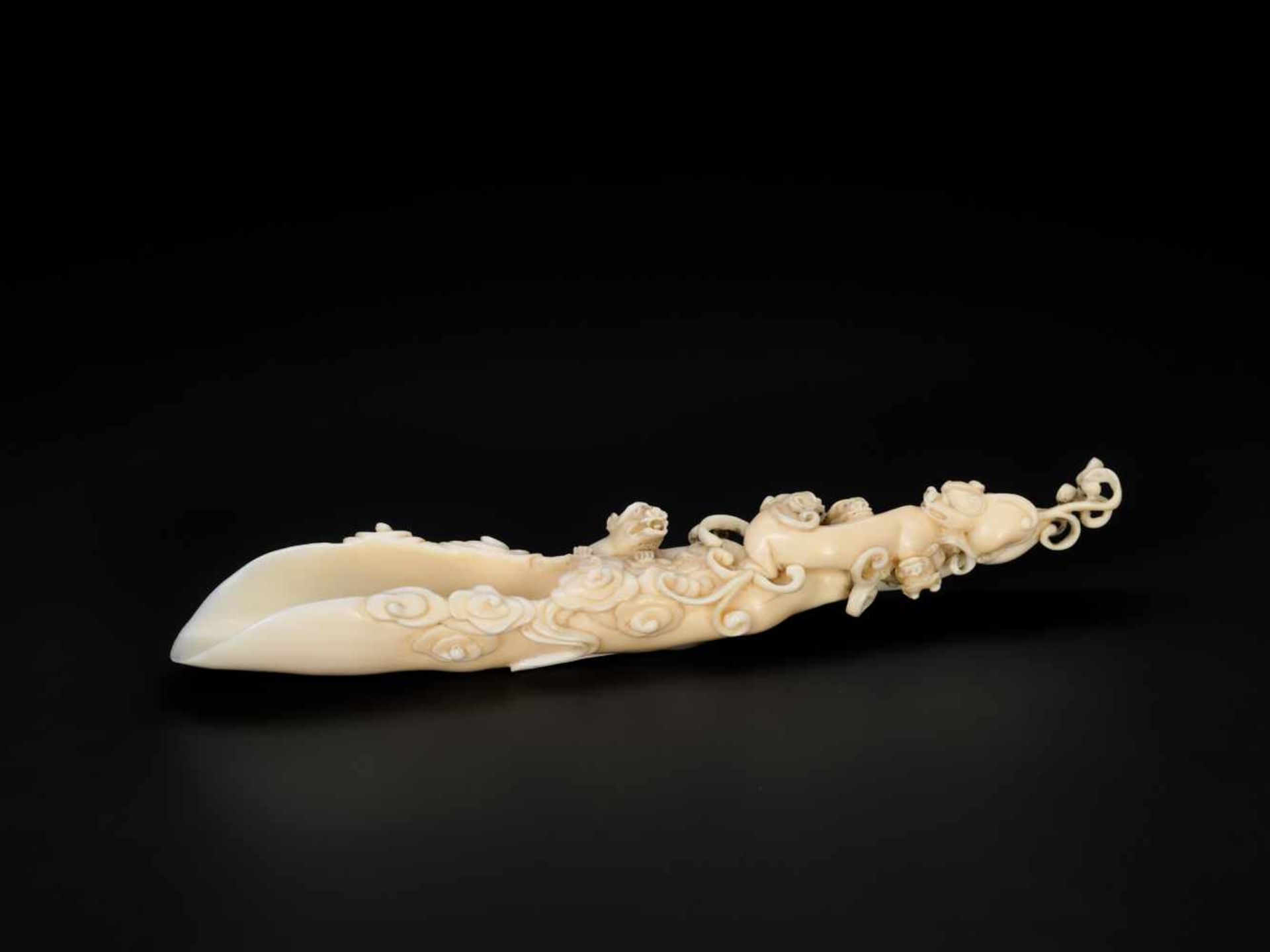 AN 18TH CENTURY IVORY RAFT-FORM POURING VESSEL WITH CHILONG Ivory China, 18th centuryThis masterly